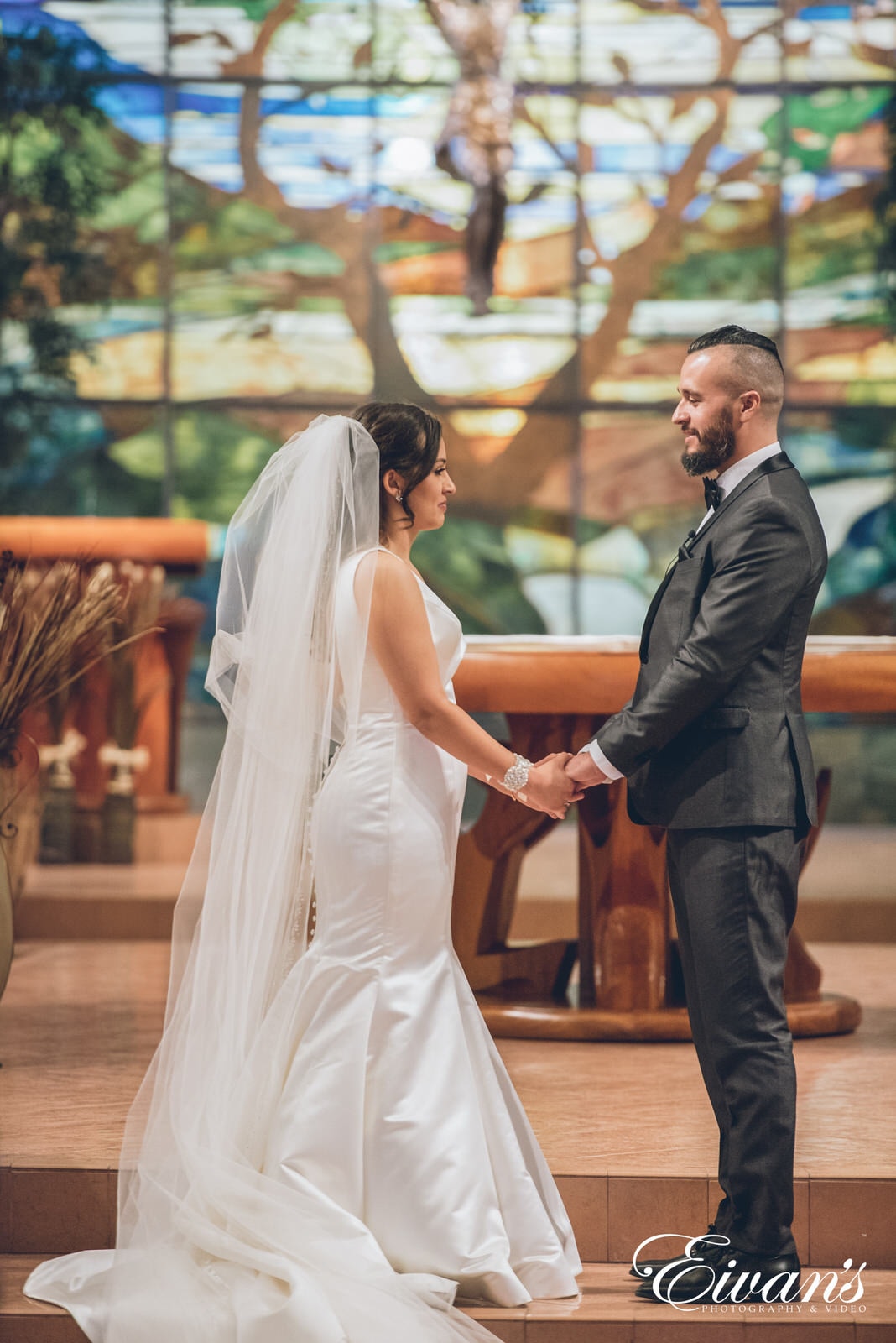 man and woman at the alter holding hands