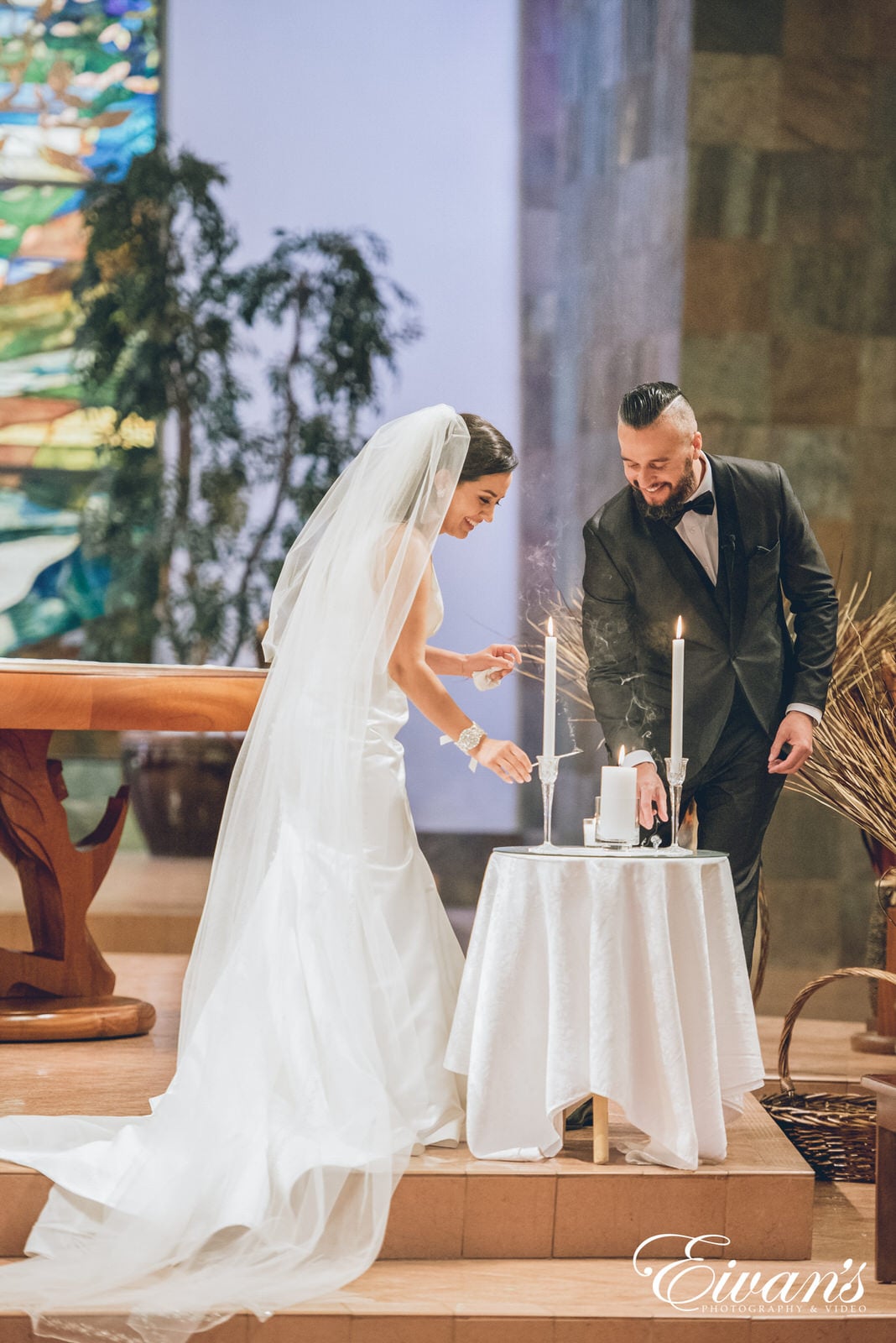 man and woman lighting a candle