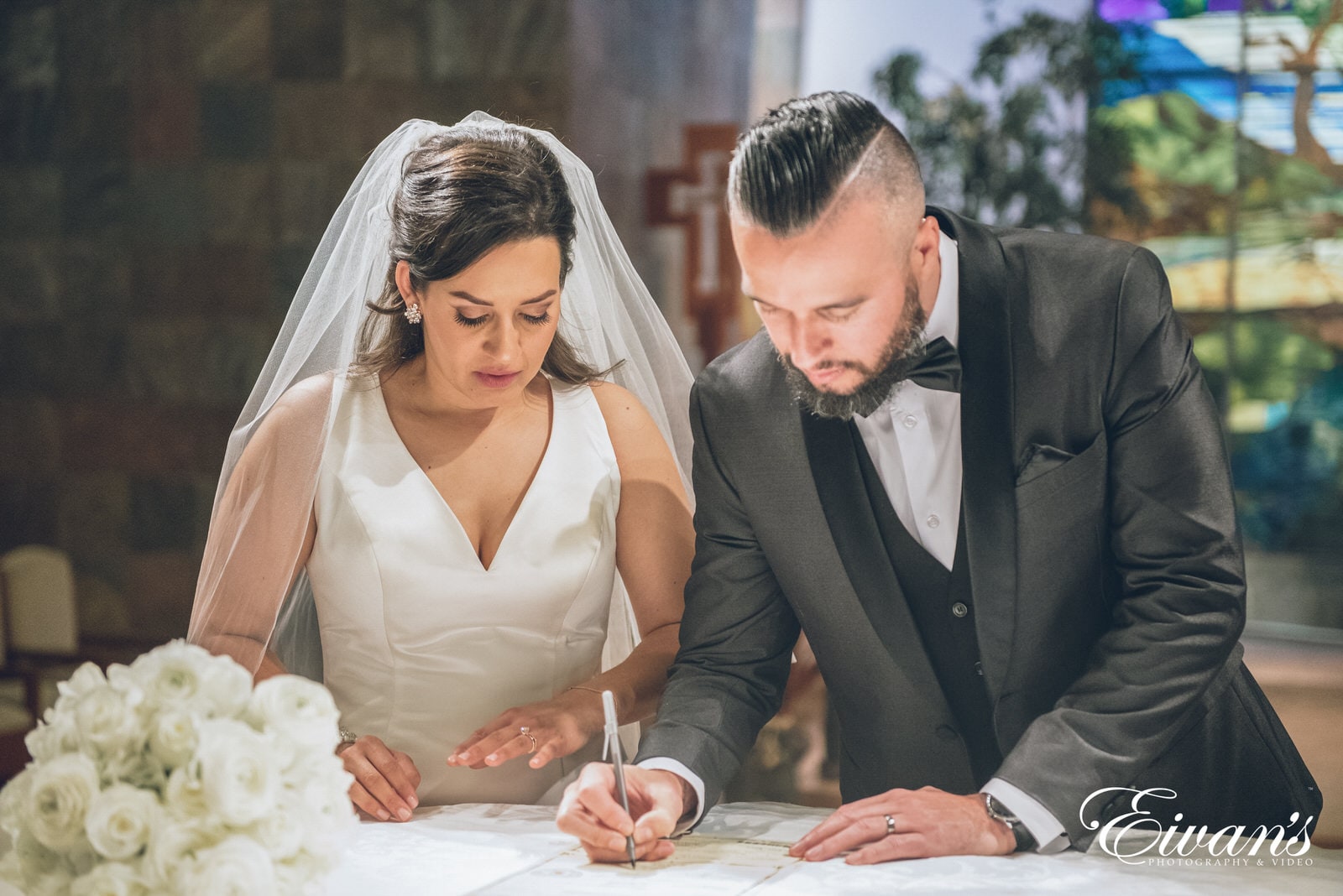 married man and woman signing their marriage license