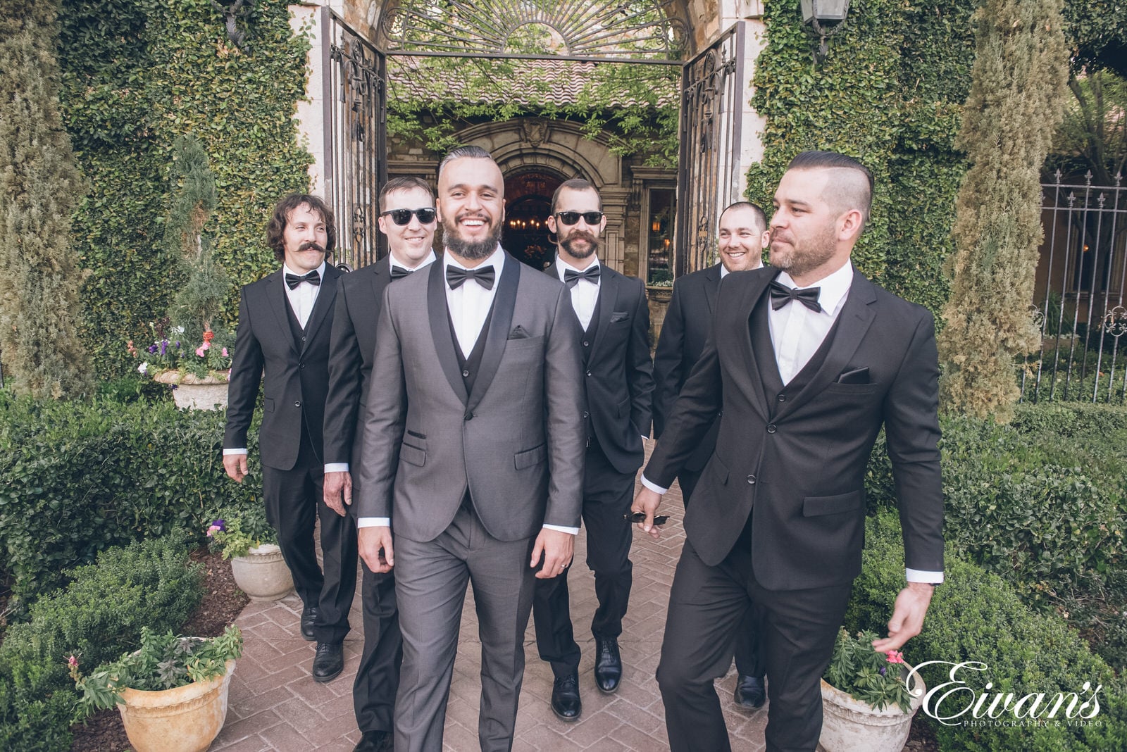 married man walking with his five groomsmen