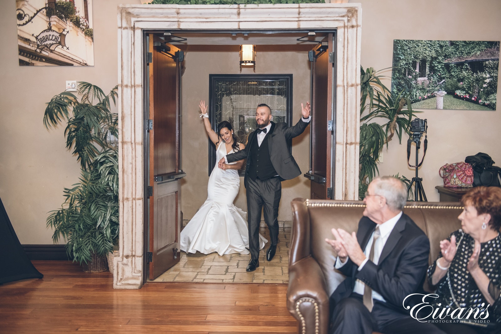 married man and woman holding hands and dancing their way into the venue