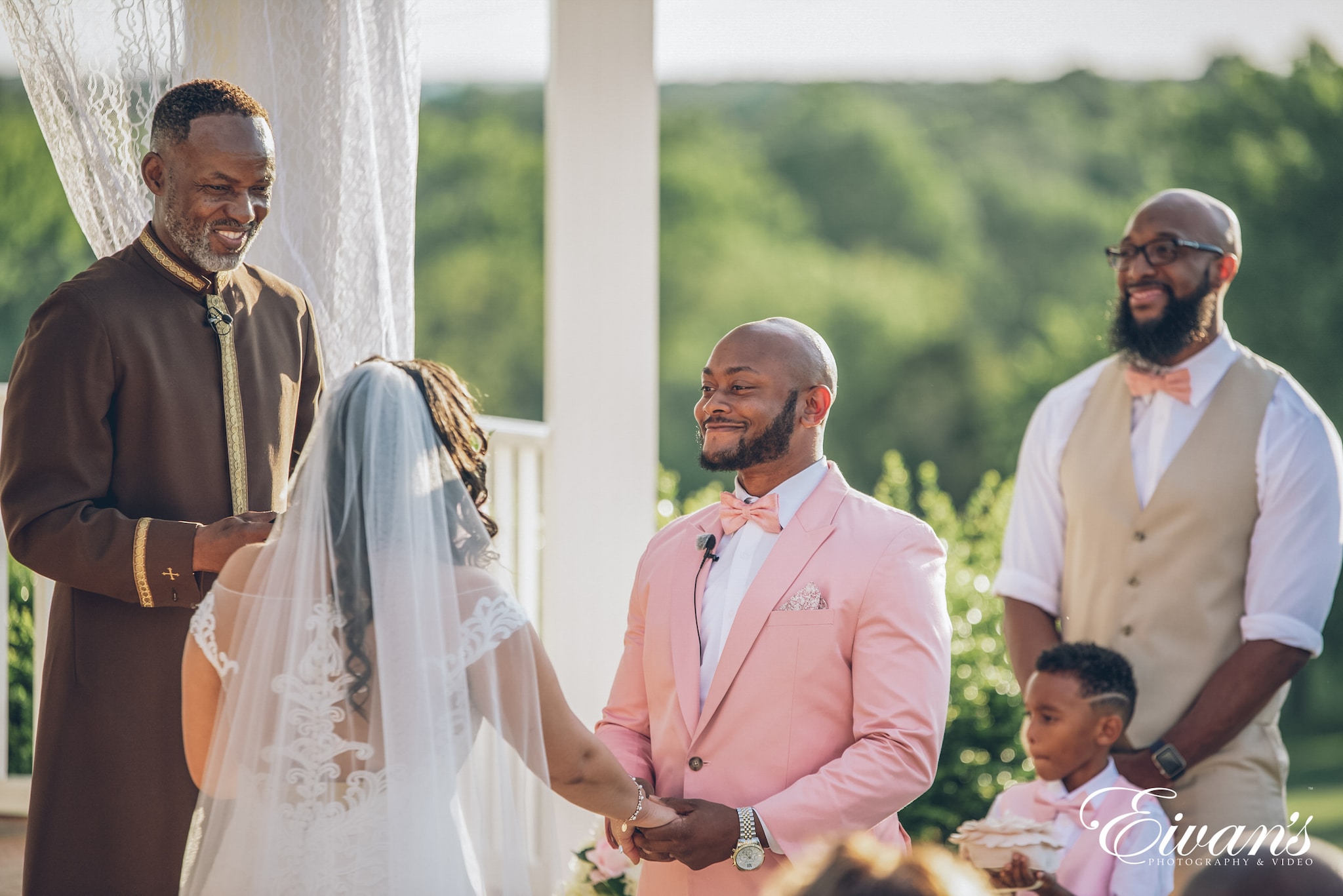 man in white suit standing beside woman in white wedding dress during daytime