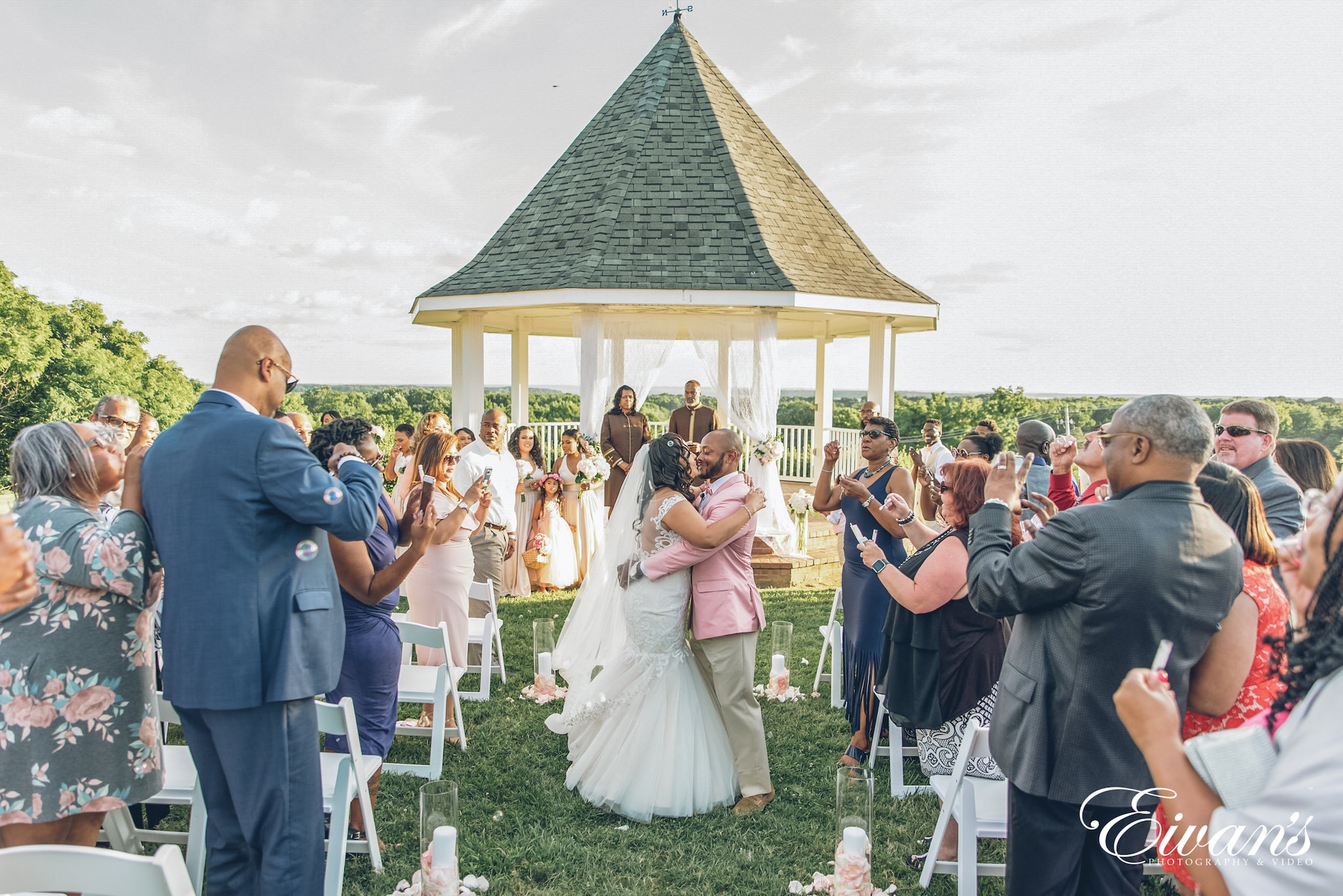 man in blue suit jacket holding hands with woman in white wedding gown