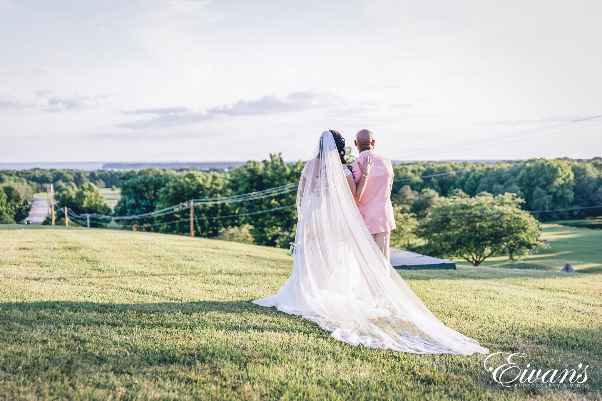 woman in white wedding dress standing on green grass field during daytime