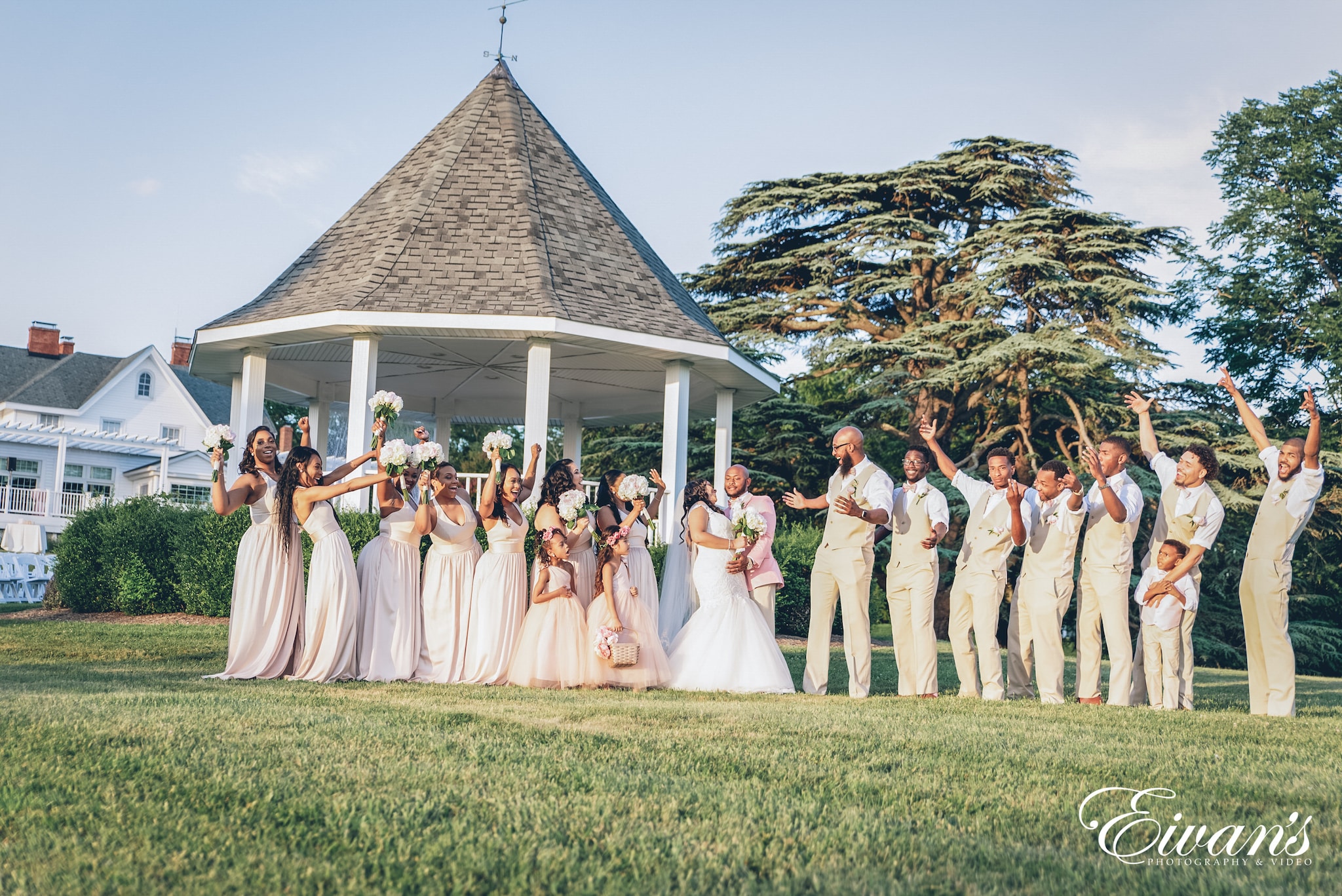 group of people in white dresses standing on green grass field during daytime