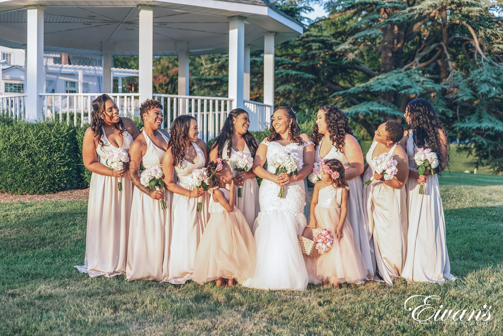 group of women in white dress standing on green grass field during daytime