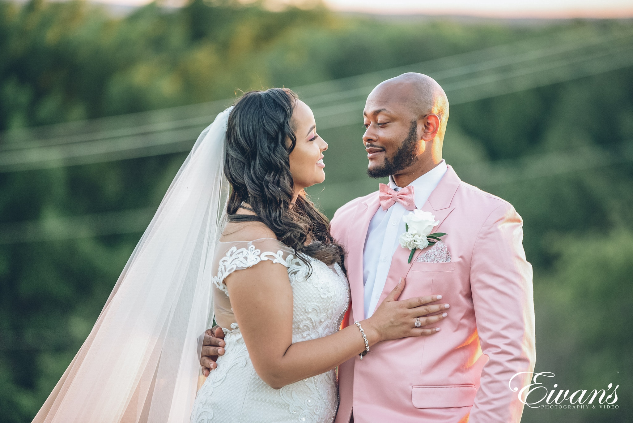 man in black suit and woman in white wedding dress