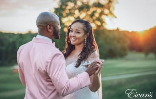 man in white dress shirt holding woman in gray dress