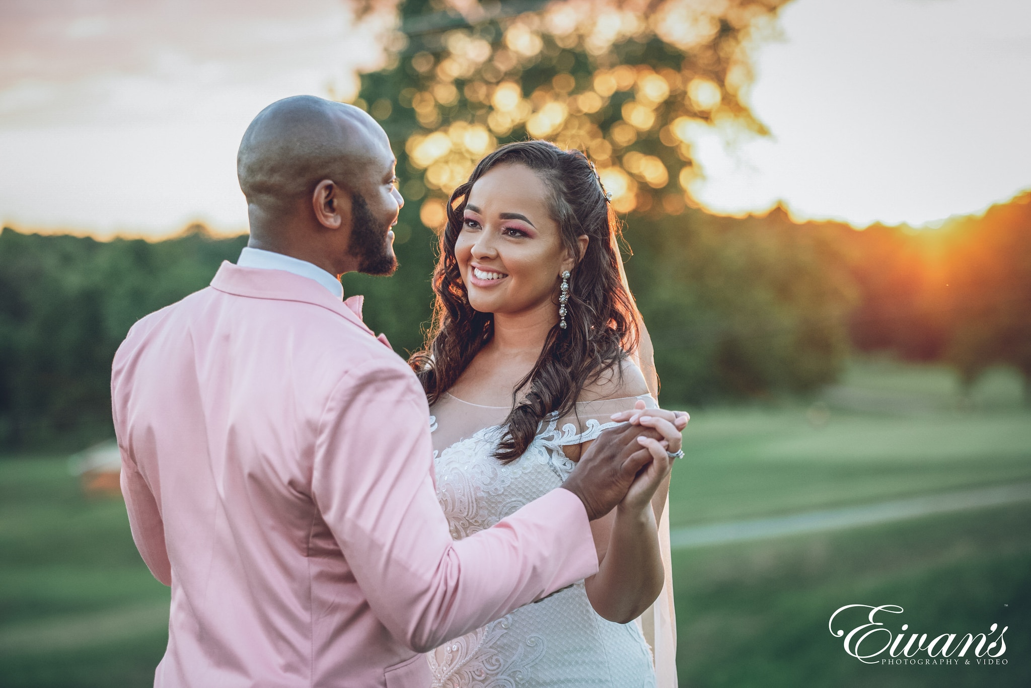 man in white dress shirt holding woman in gray dress