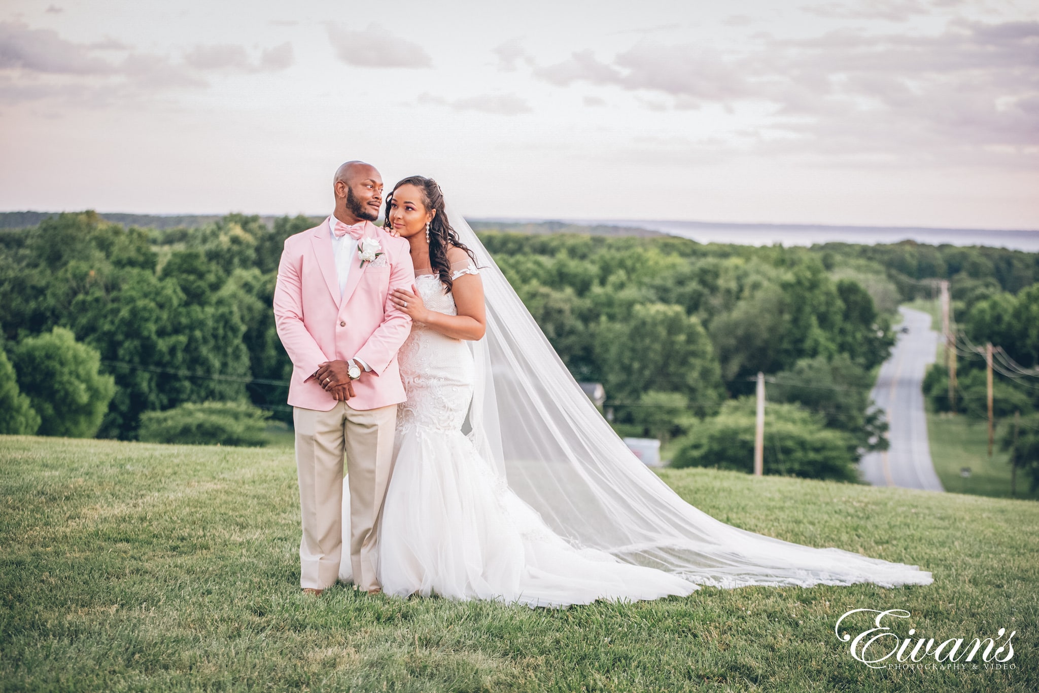 man in pink suit and woman in white dress