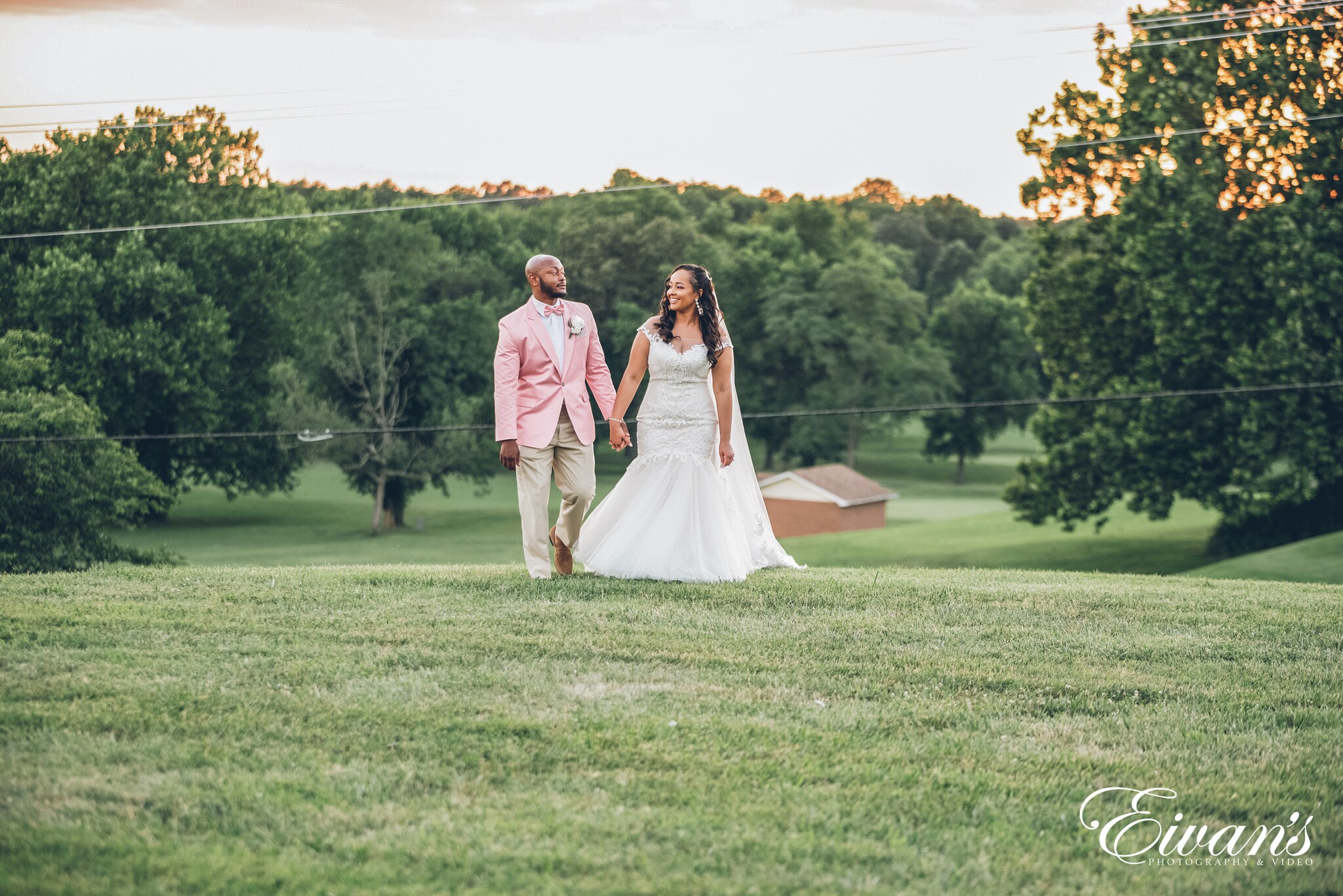 man and woman standing on green grass field during daytime