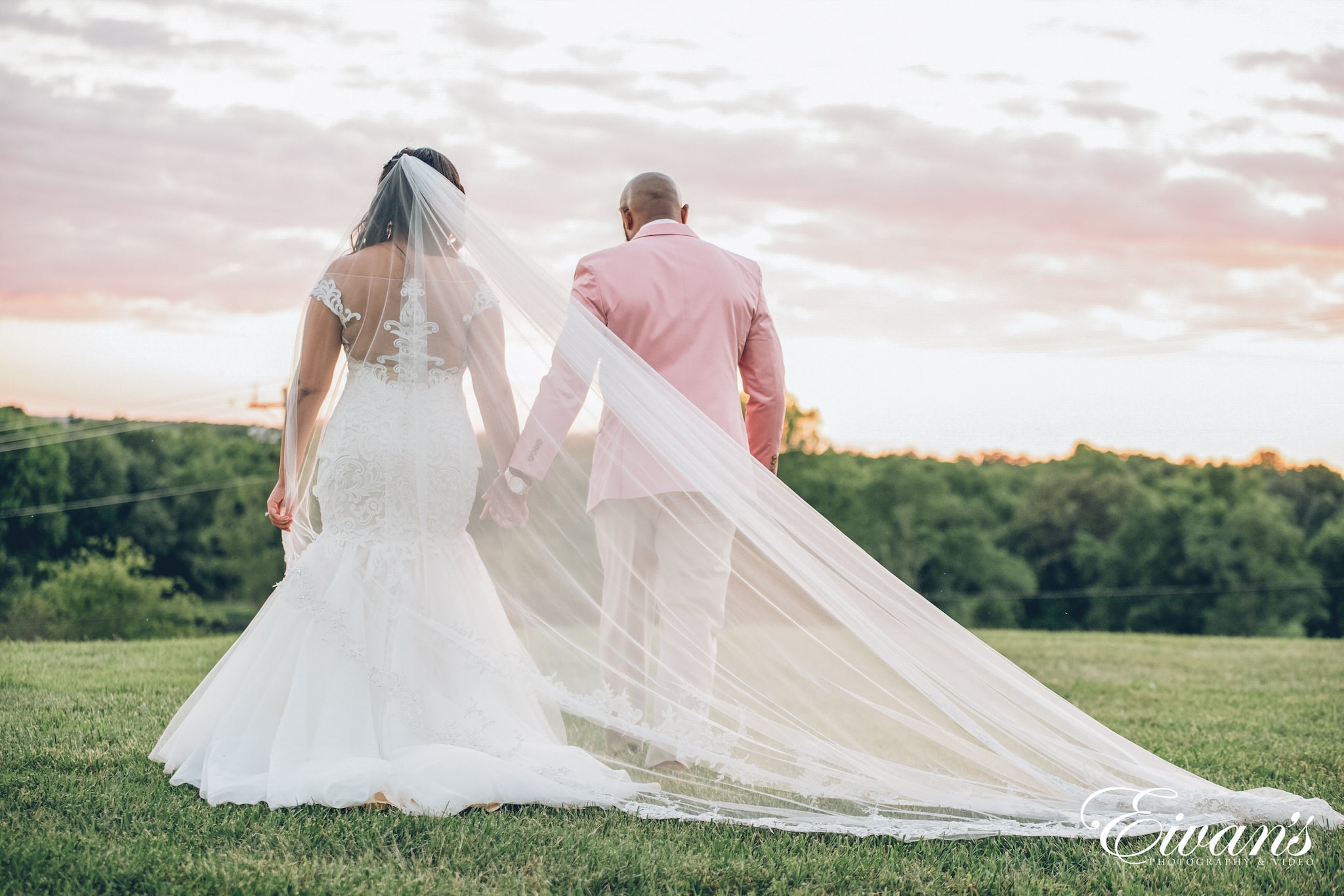 man and woman in wedding dress walking on green grass field during daytime