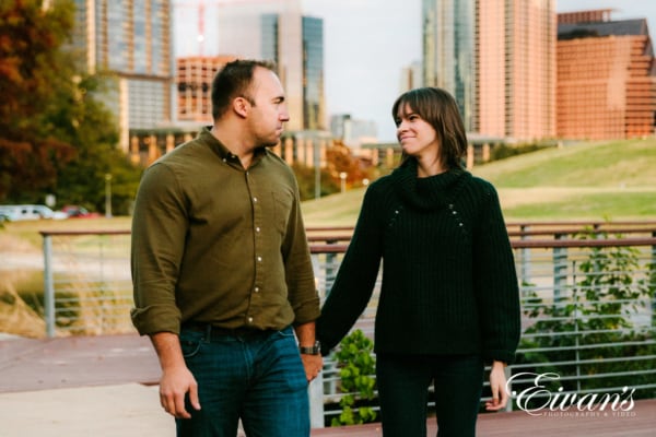 classic pose of engagement couple walking in park