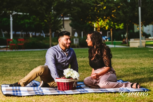 engagedcouple sitting in front of their university campus