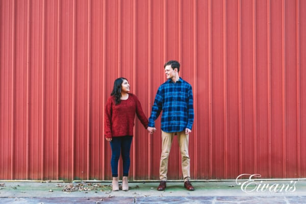 engaged couple in red and blue complimentary outfits