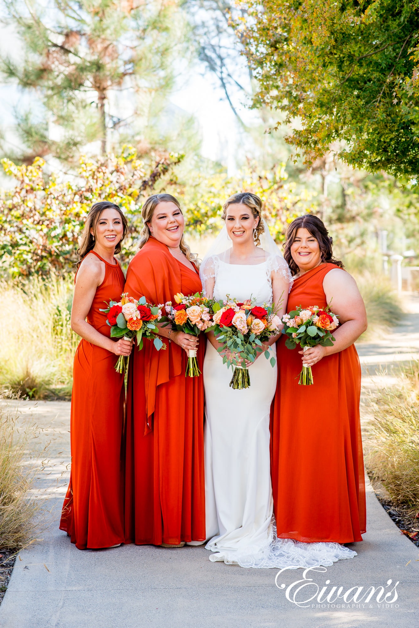 four women in red dress holding bouquet of flowers