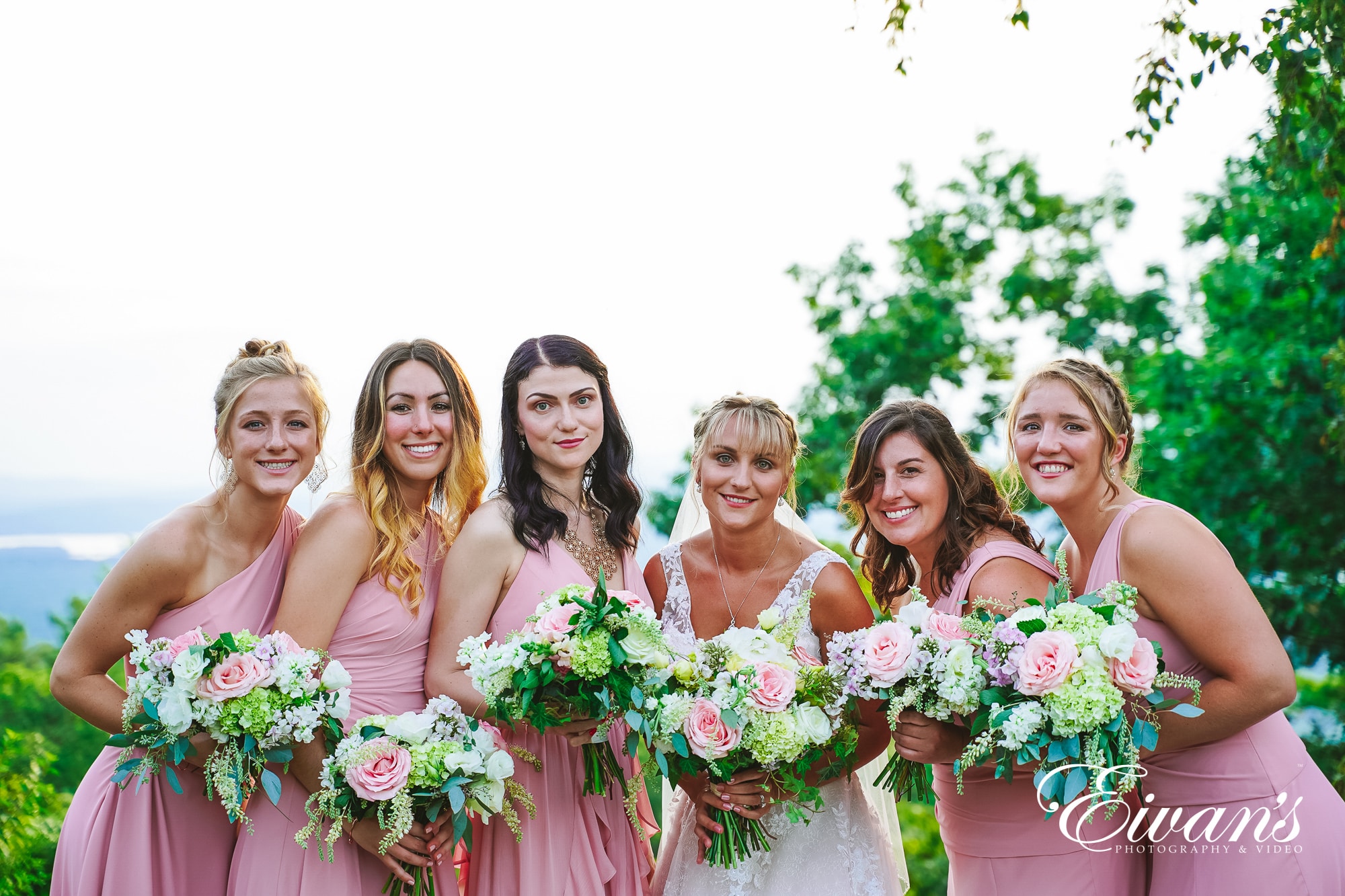 six women holding bouquet of flowers