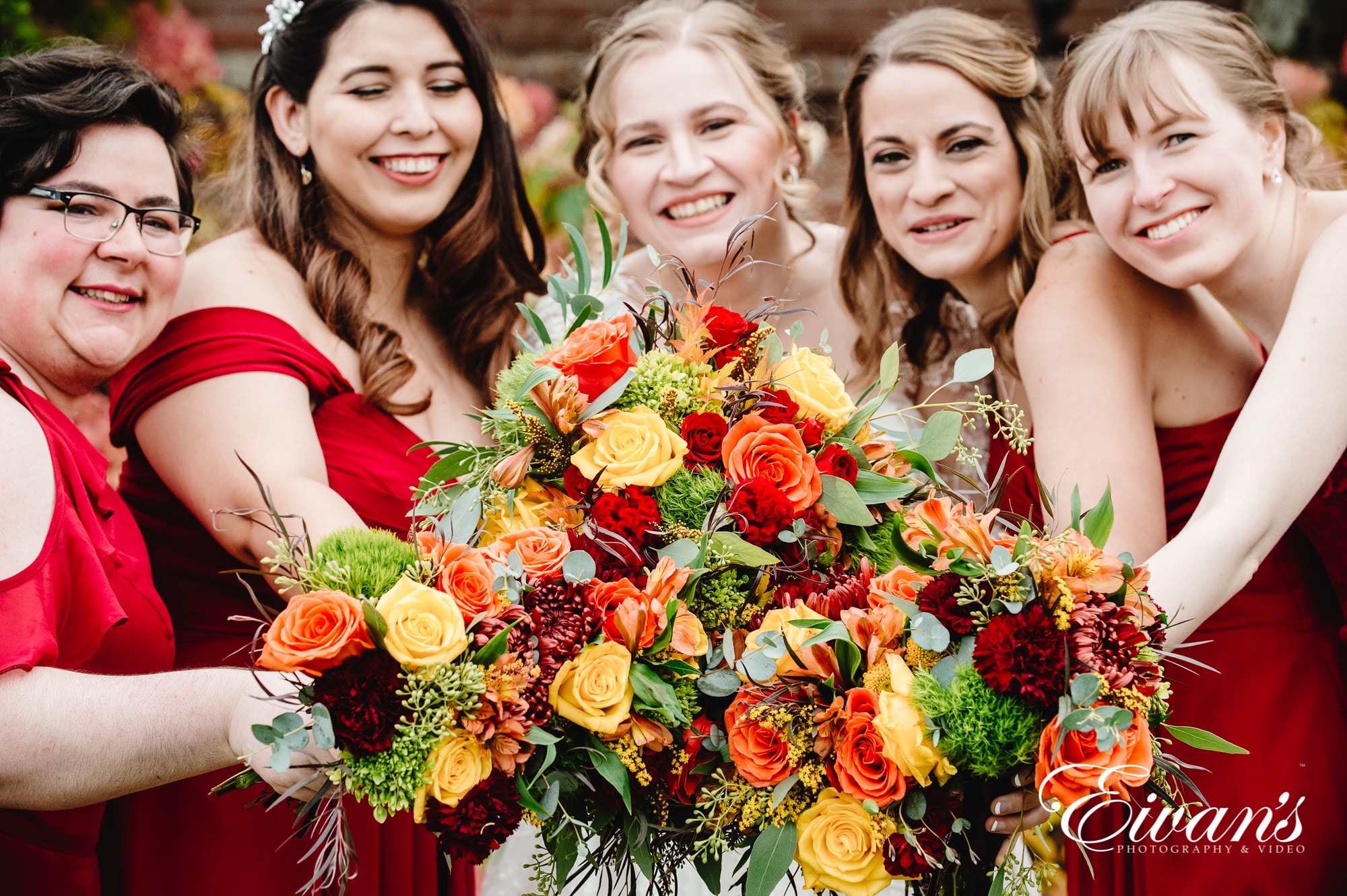 woman in red dress holding bouquet of flowers