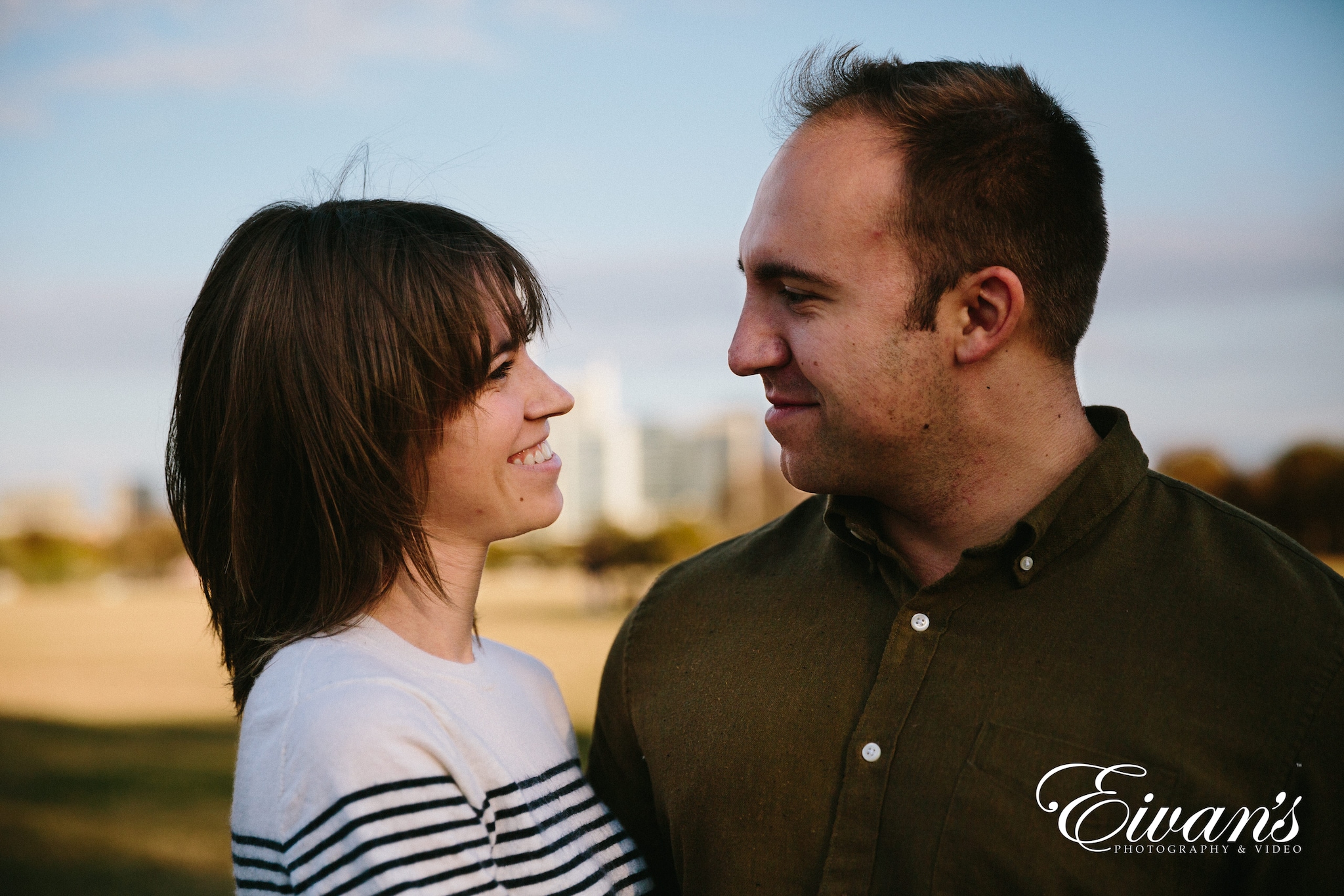 man in black button up shirt beside woman in white and black striped shirt