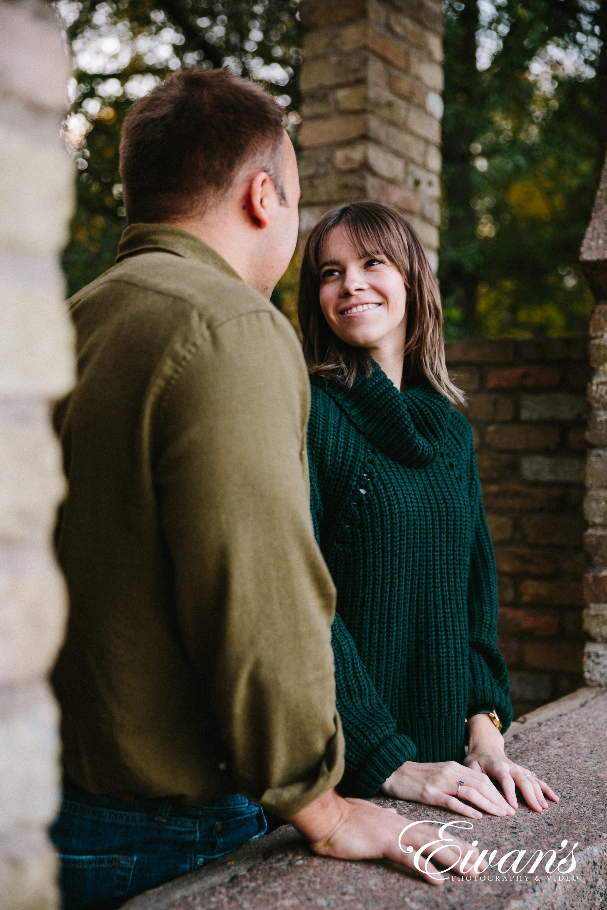 engaged female smiling in her green sweater