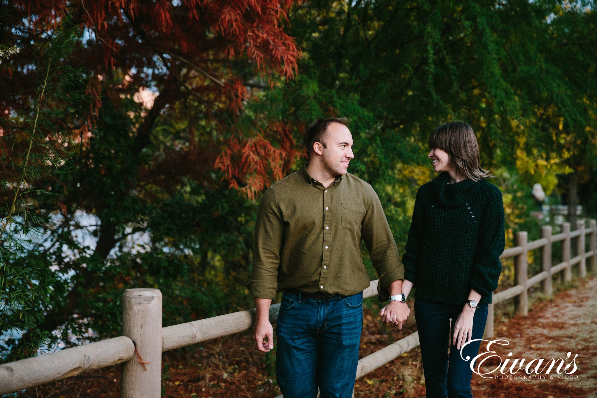 couple walk through a park