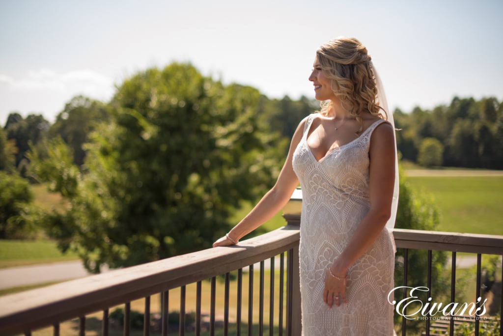 barn-wedding-photos image of a bride looking off into the distance on a balcony