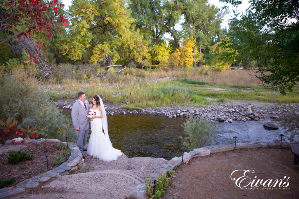 barn-wedding-photos married couple posed in front of a pond