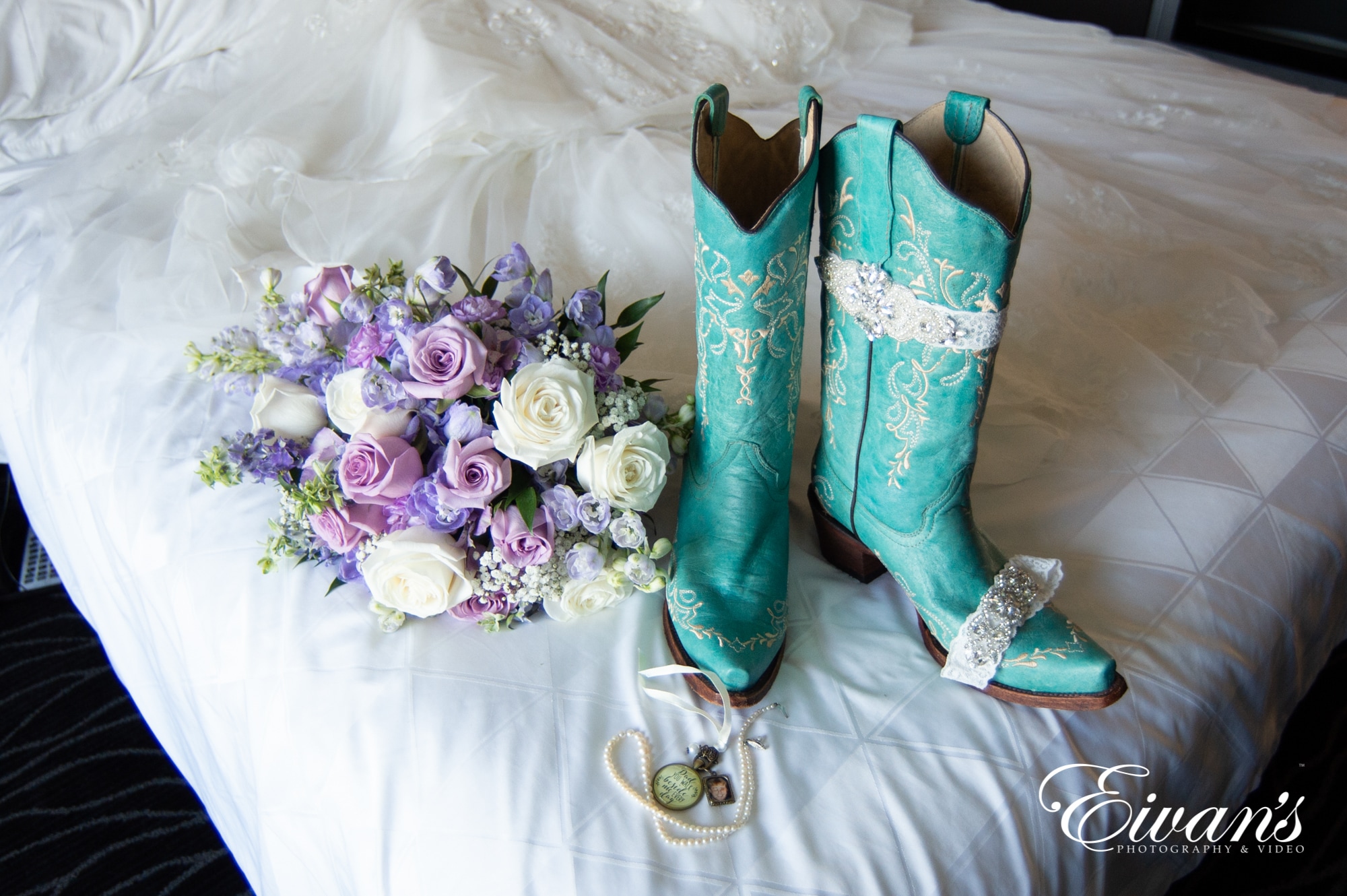 spring-wedding-colors image of boots and a bouquet on a bed