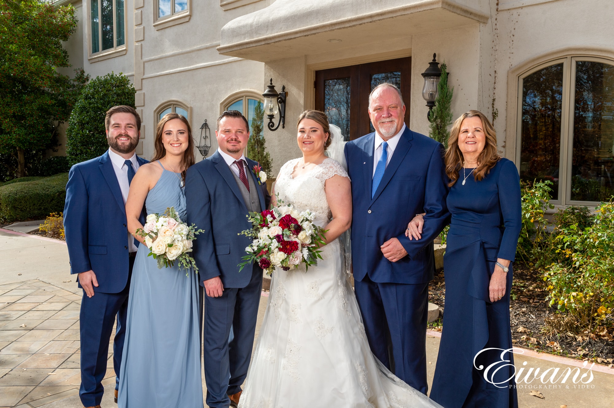 image of a married couple standing with family members.