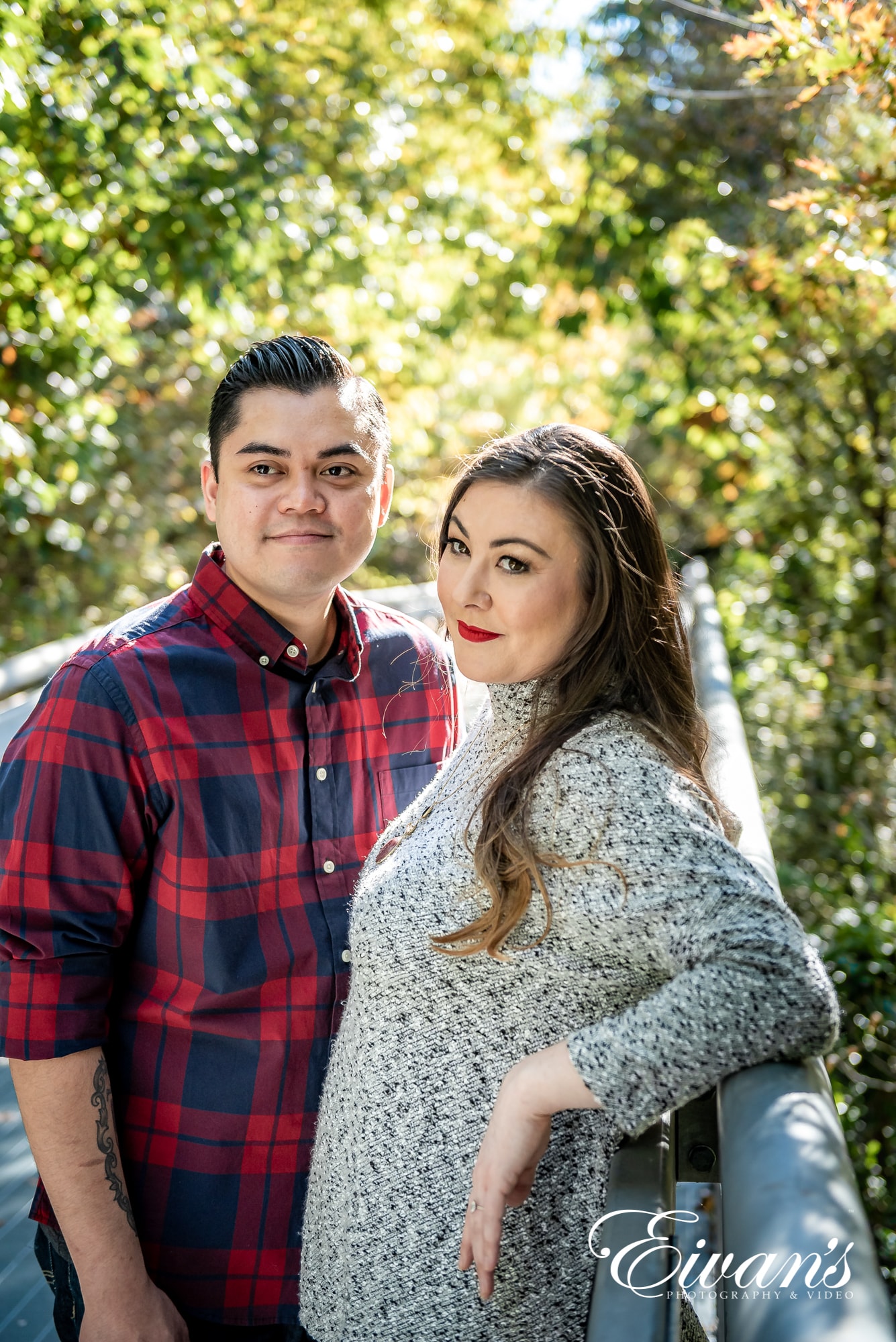 engaged man and woman posing in a forest