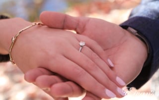 engaged man holding his fiancees hand