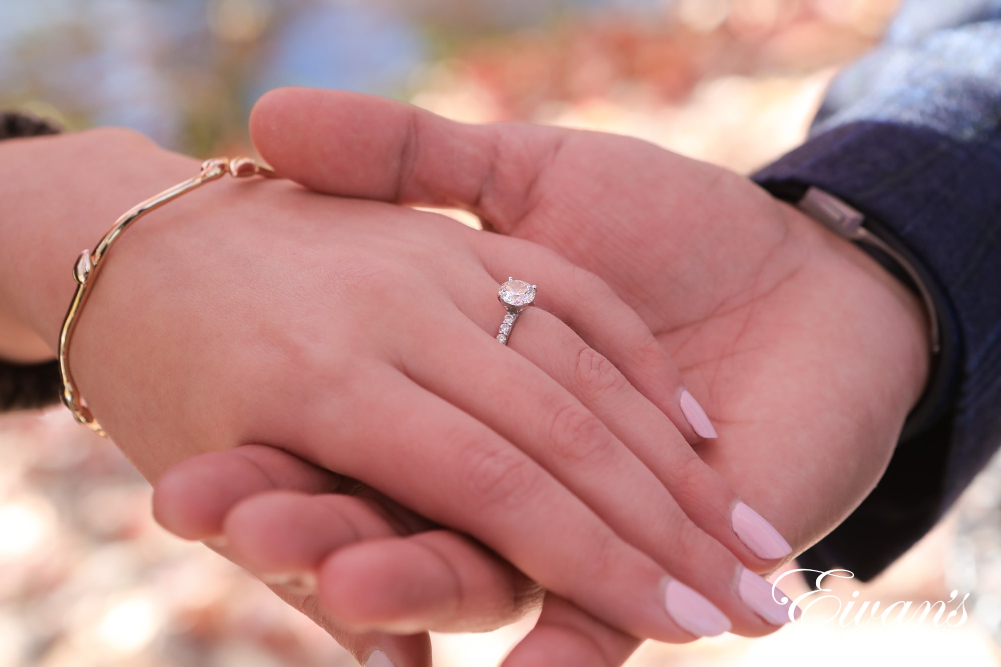 engaged man holding his fiancees hand