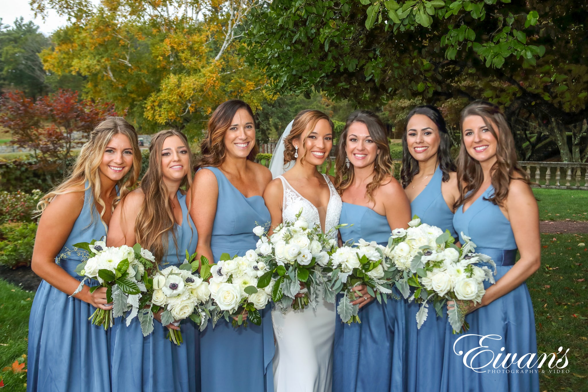 a bride and her bridesmaids lined up for a picture