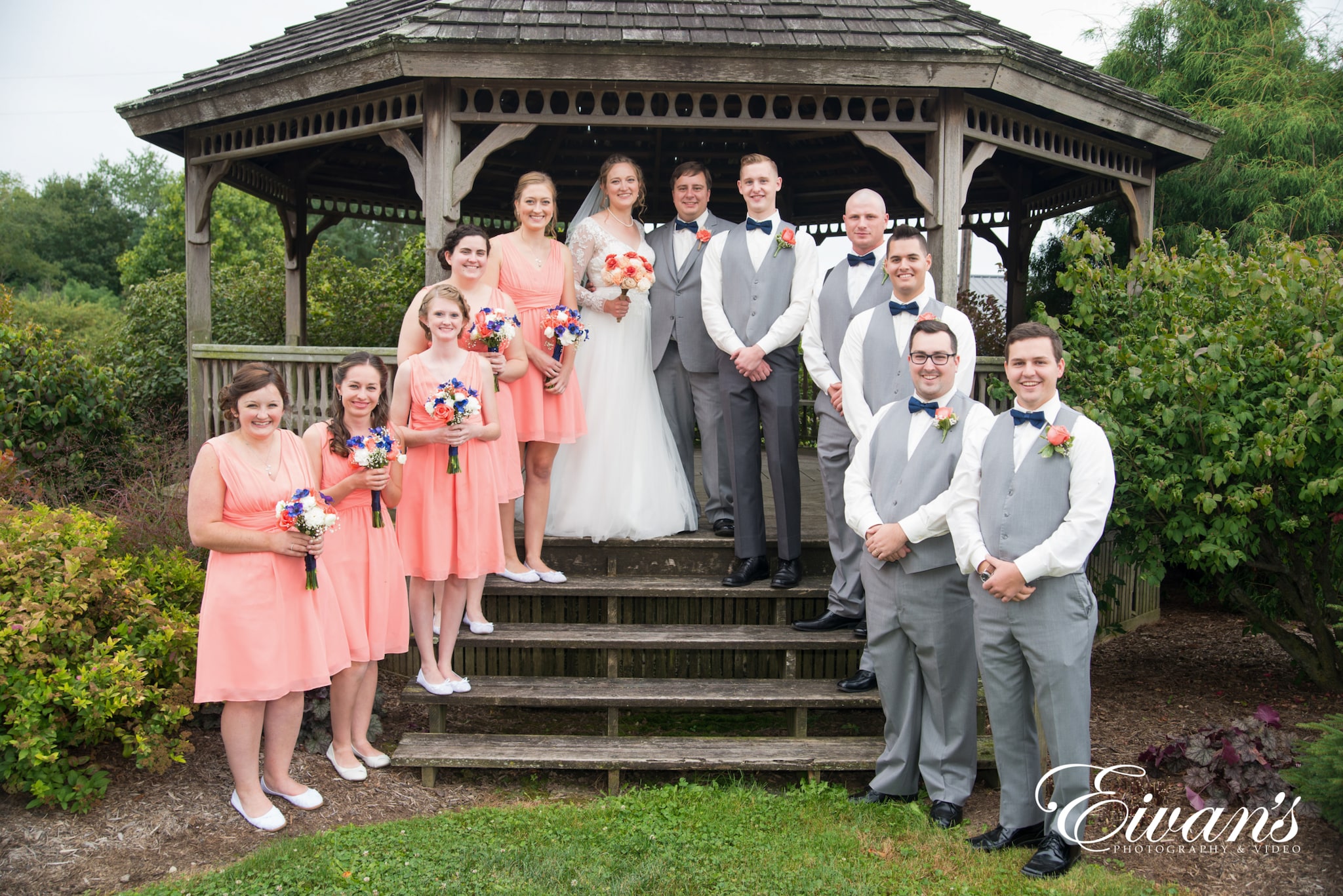 bride and groom with the wedding party on the stairs