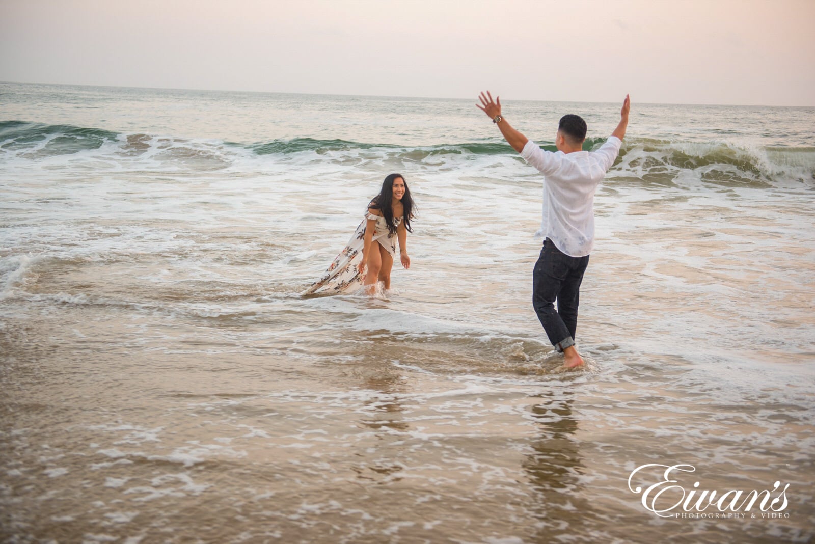 cute-engagement-photos man in white shirt and black pants standing on beach during daytime