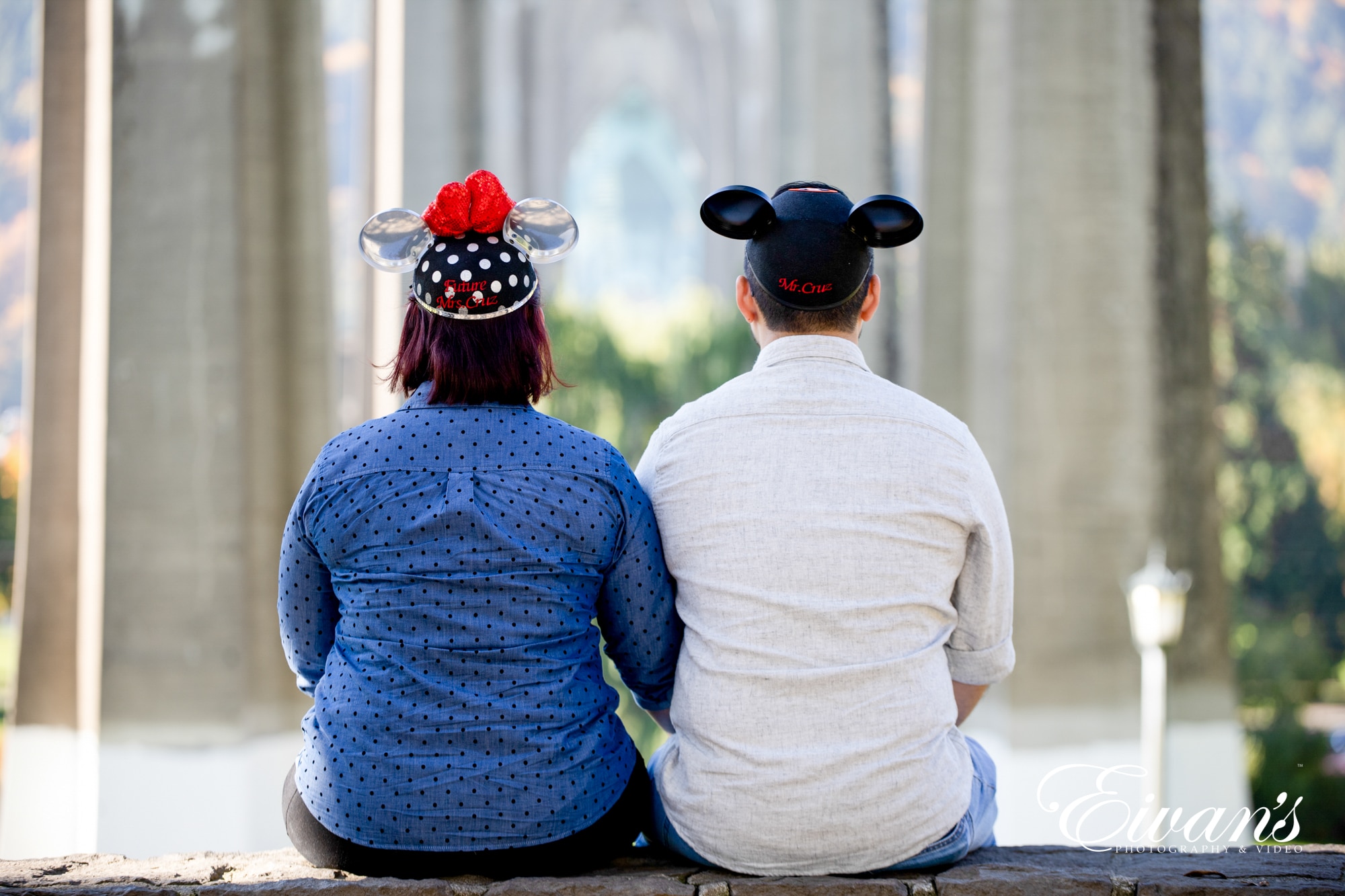 Image of an engaged couple wearing Mickey Mouse hats