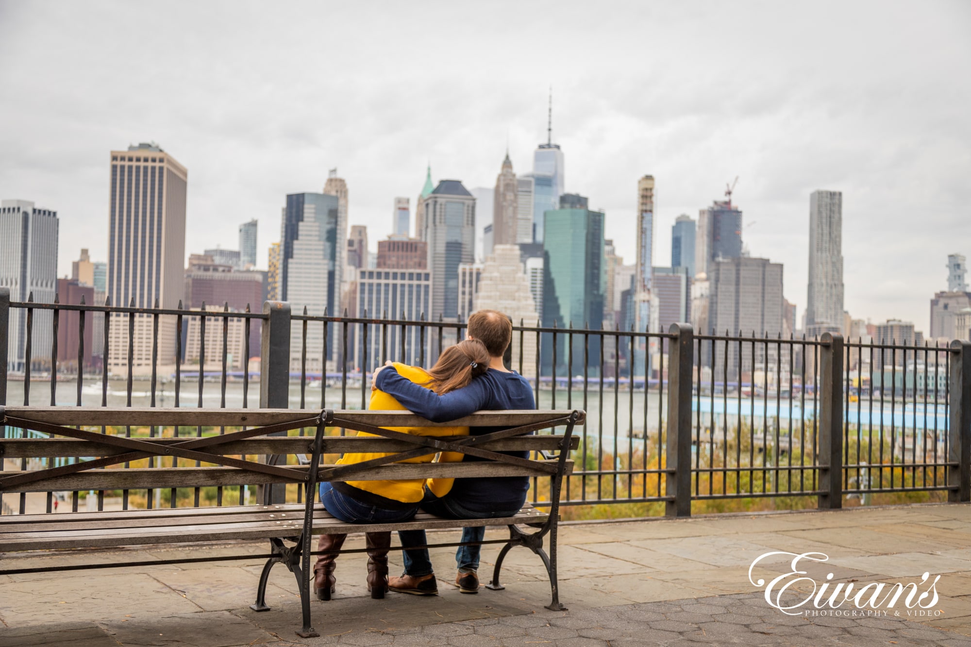 Image of an engaged man and woman sitting on a bench