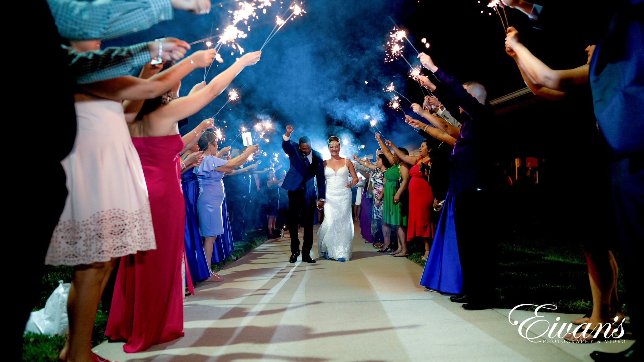 image of married couple walking through their guests