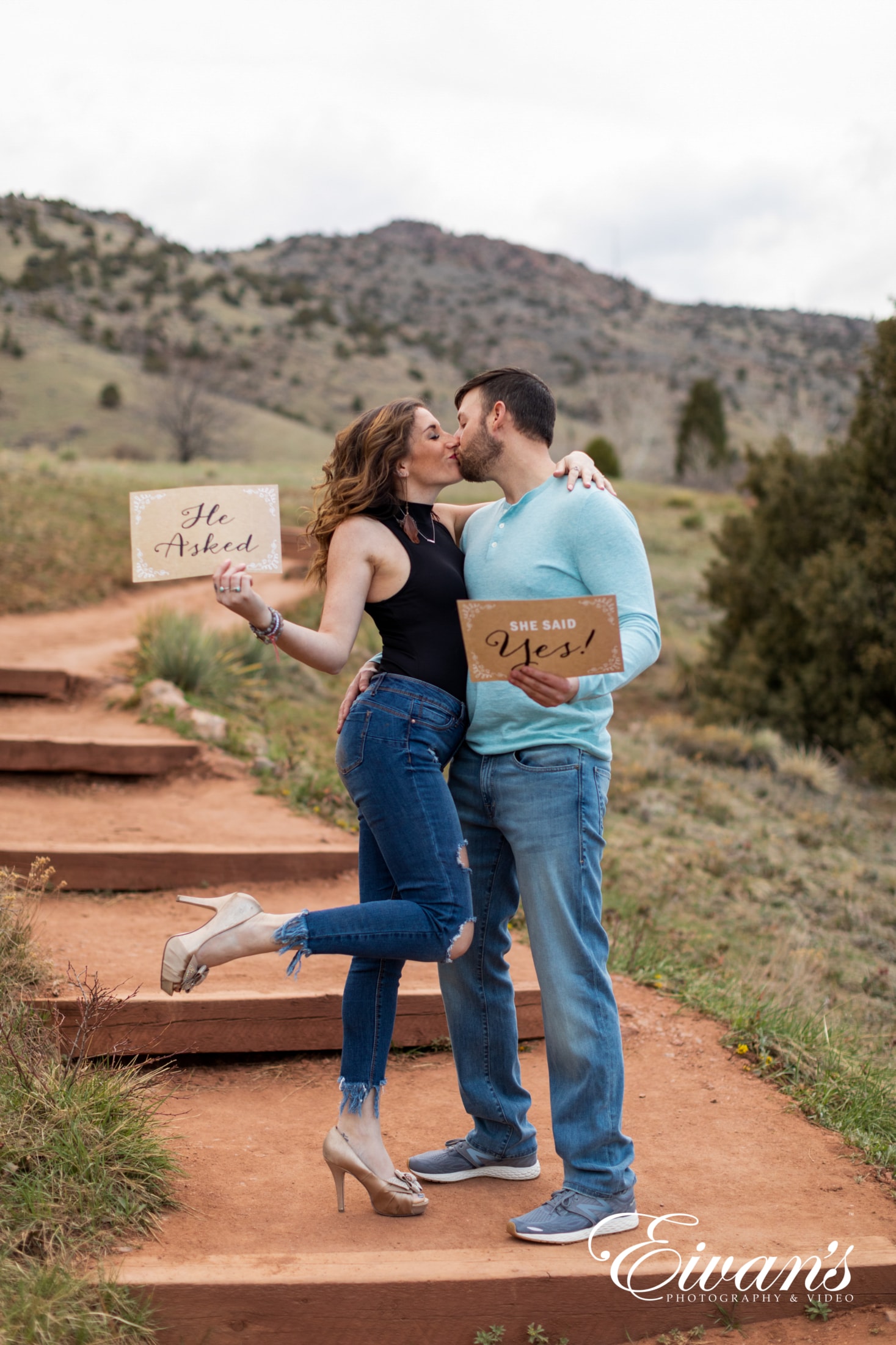 image of an engaged couple holding up signs