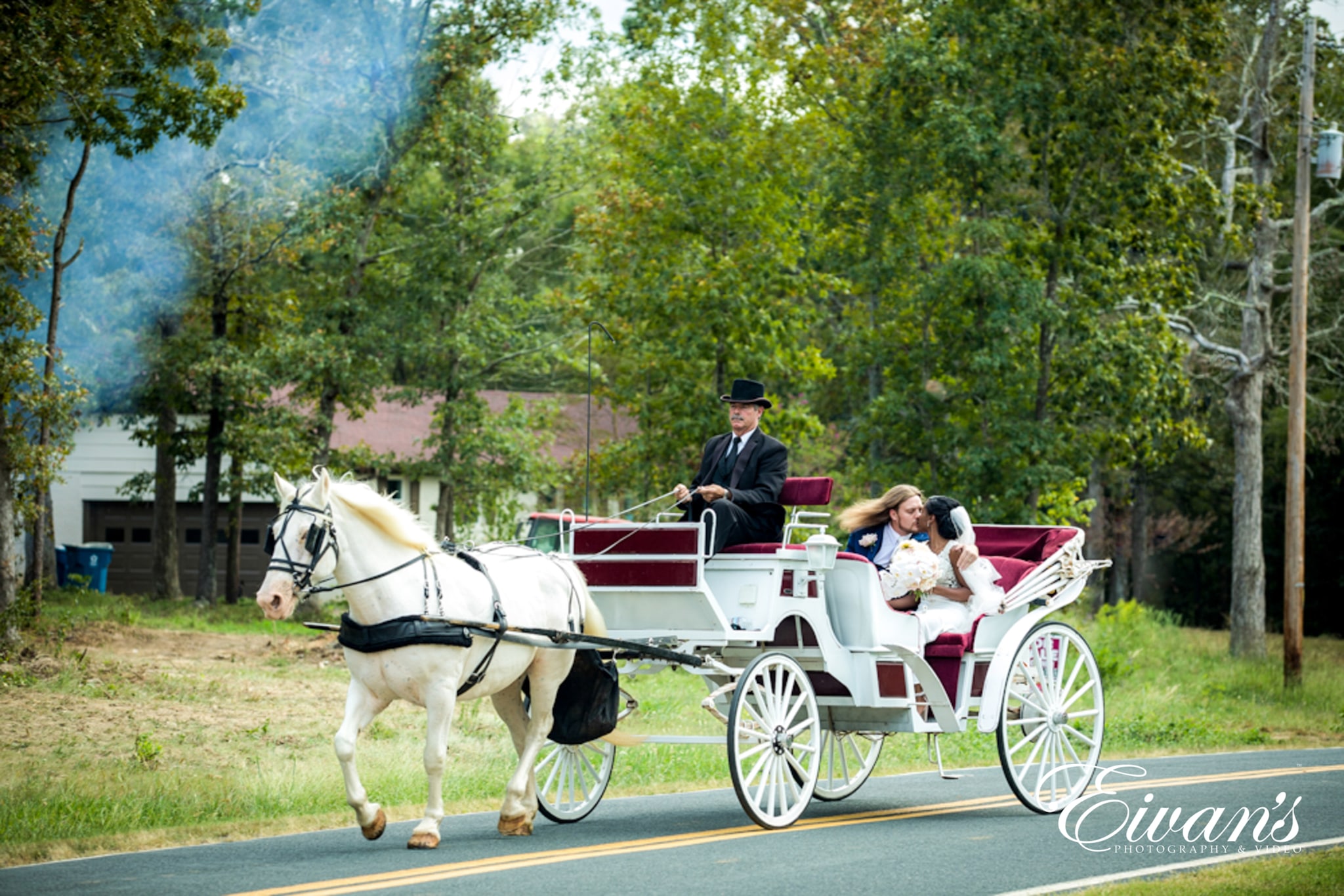 image of bride and groom hitching a ride on a carriage