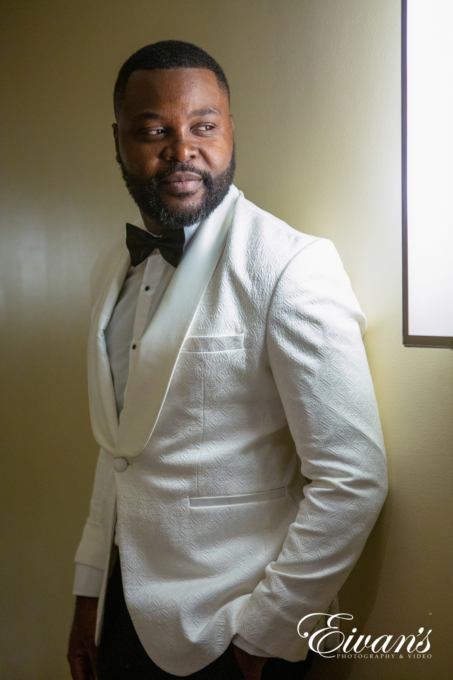 image of a groom in a white jacket