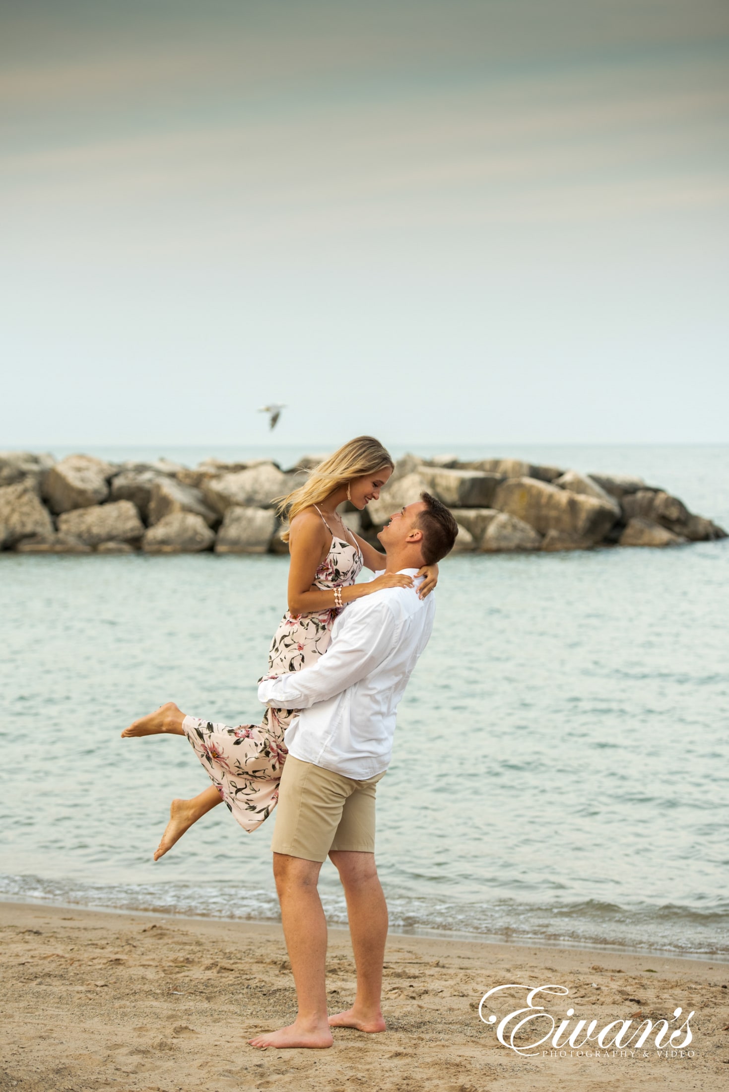 image of an engaged couple on the beach