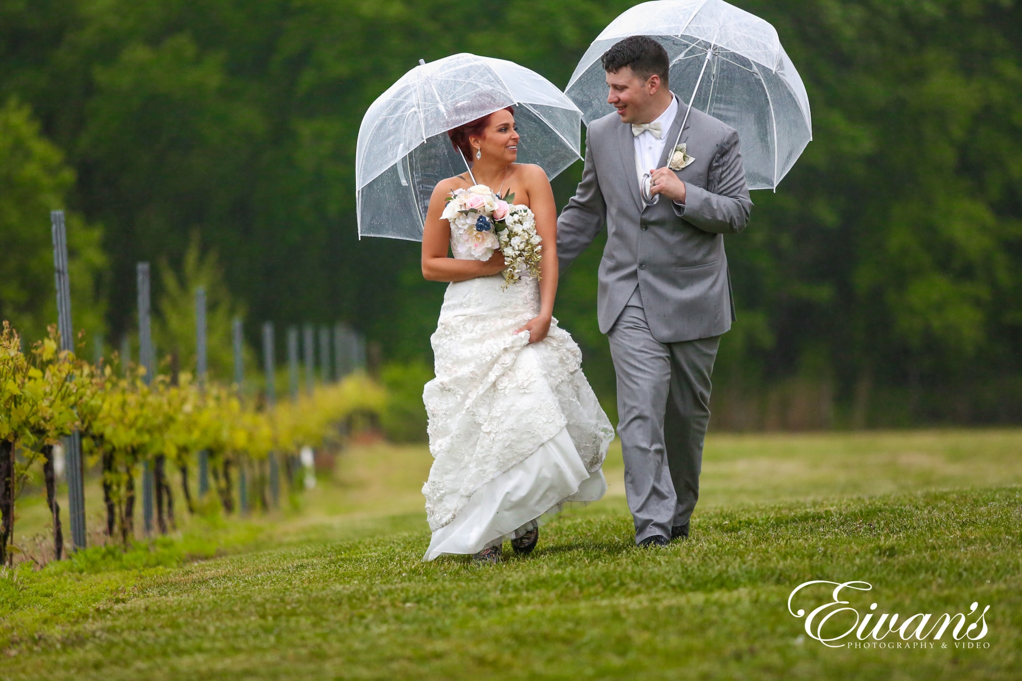 image of a bride and groom walking in the rain