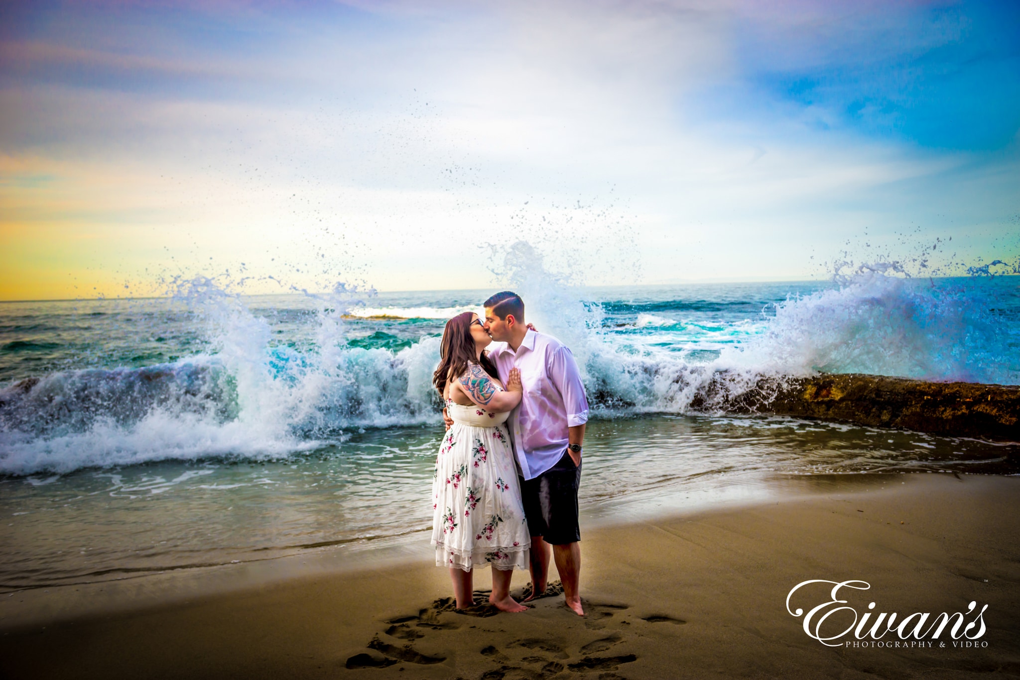 image of an engaged couple in front of waves