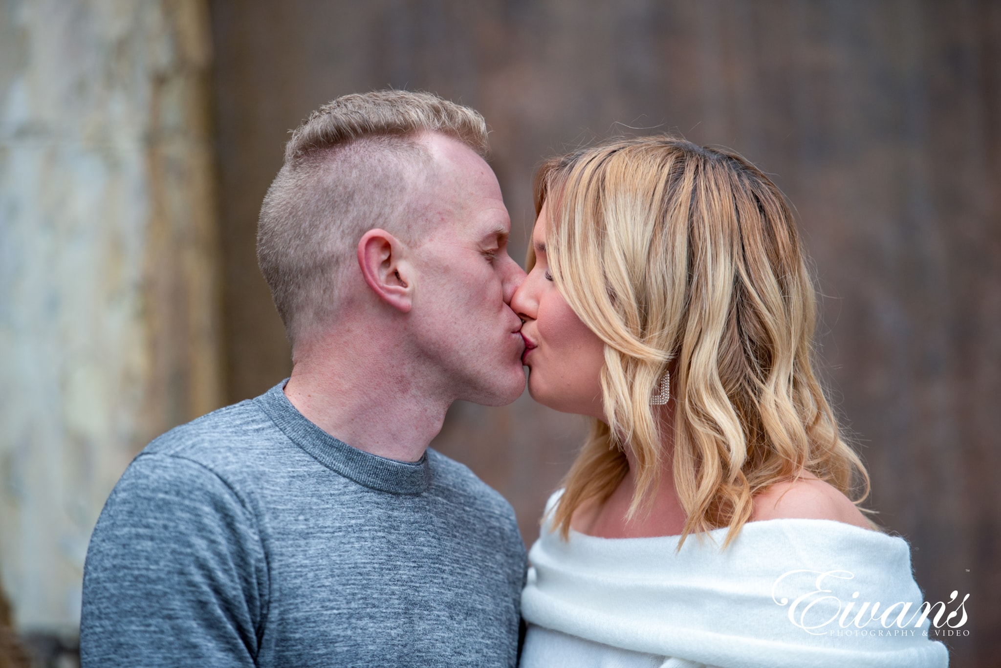 image of engaged man and woman kissing