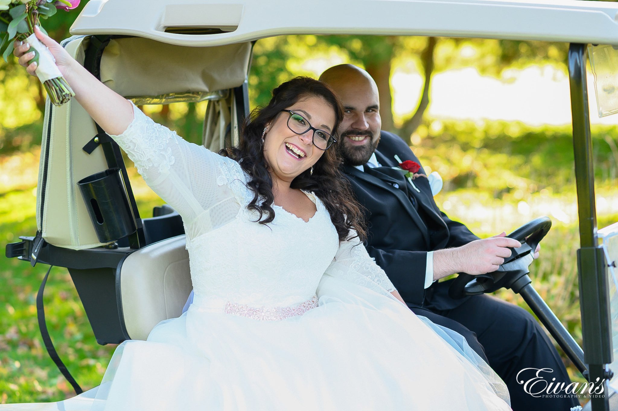 image of a married couple in a gold cart