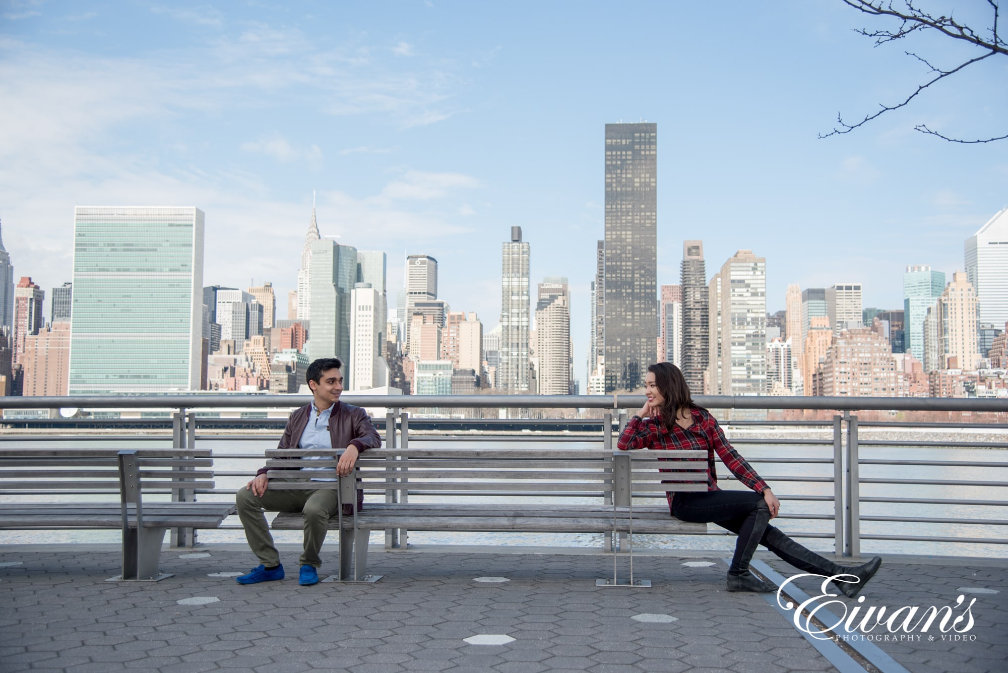 cute-engagement-photos image of a couple looking at each other from across the bench