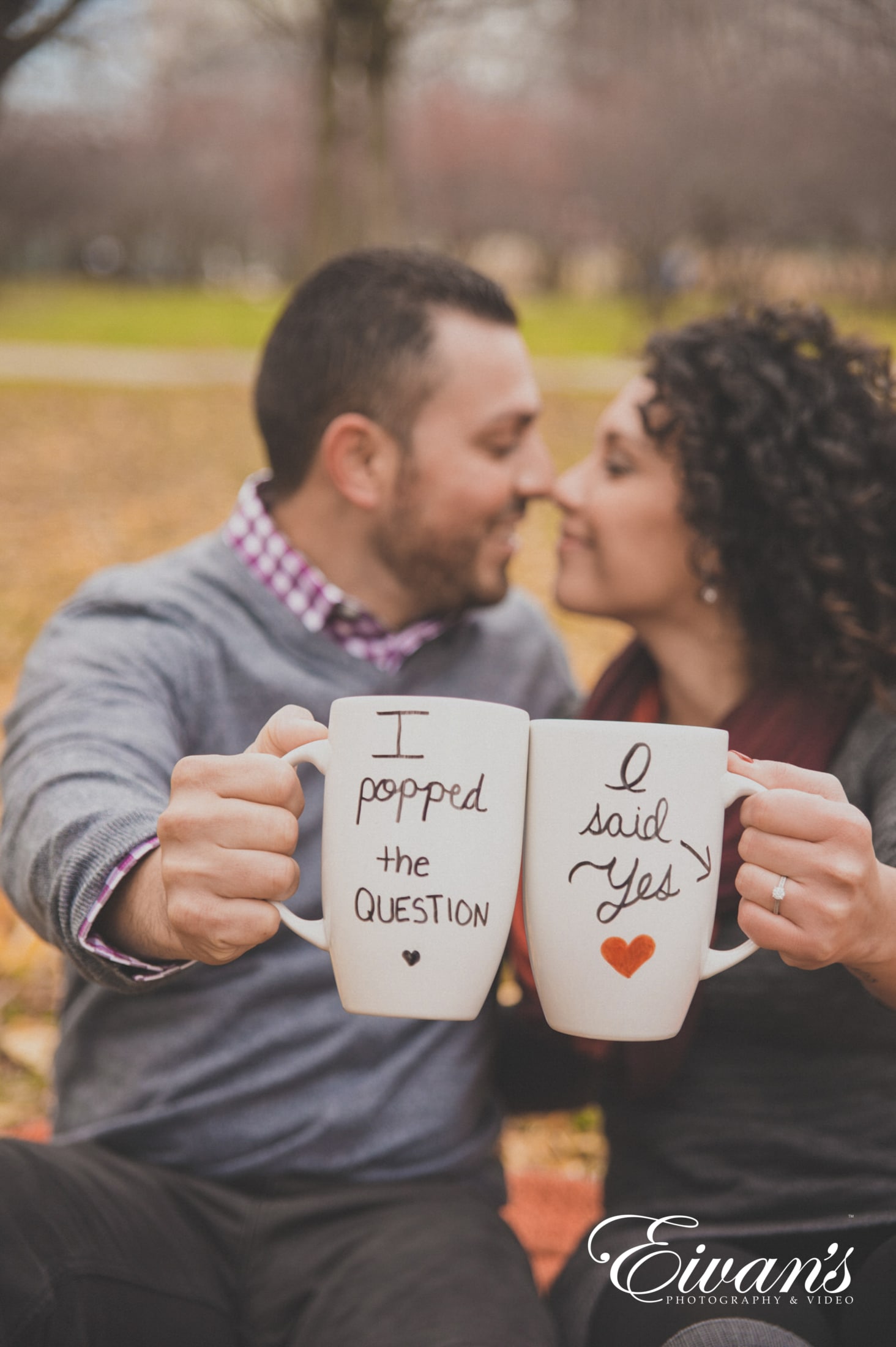 image of a couple kissing and holding mugs