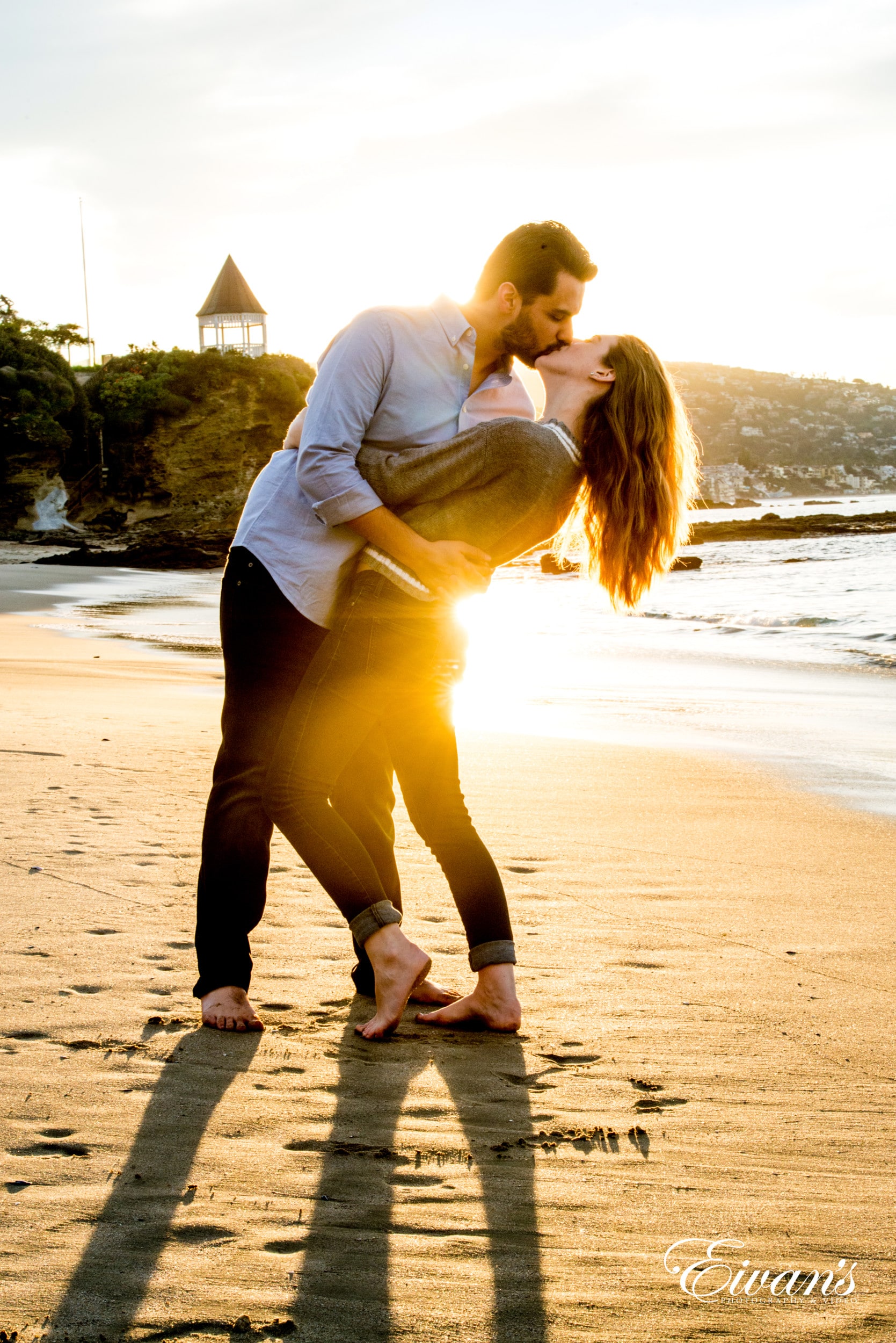 man and woman kissing on beach during daytime