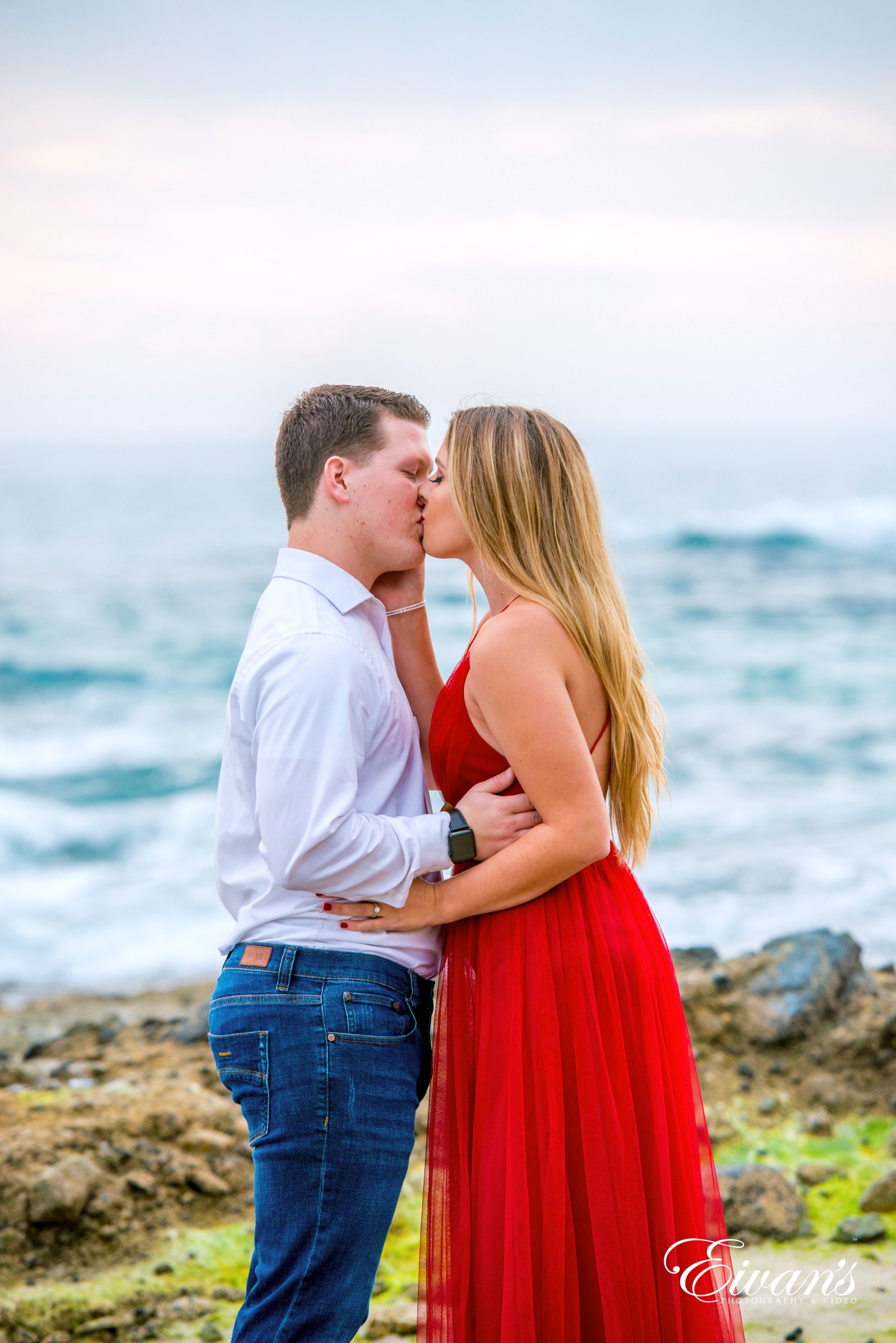 man and woman kissing on beach during daytime